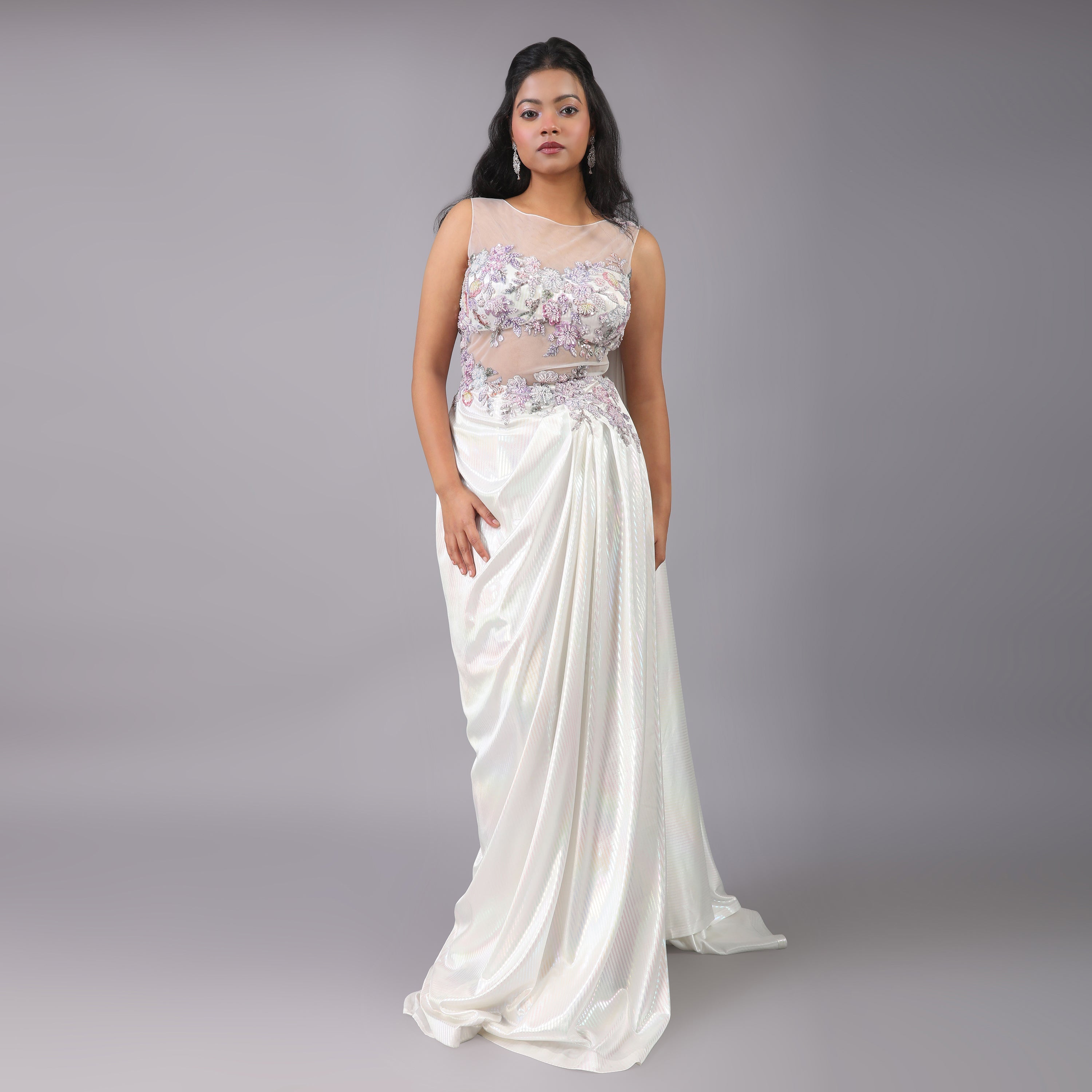 Stunning Holographic White multicolor pre-draped saree gown with floral embellishments on it. - qivii