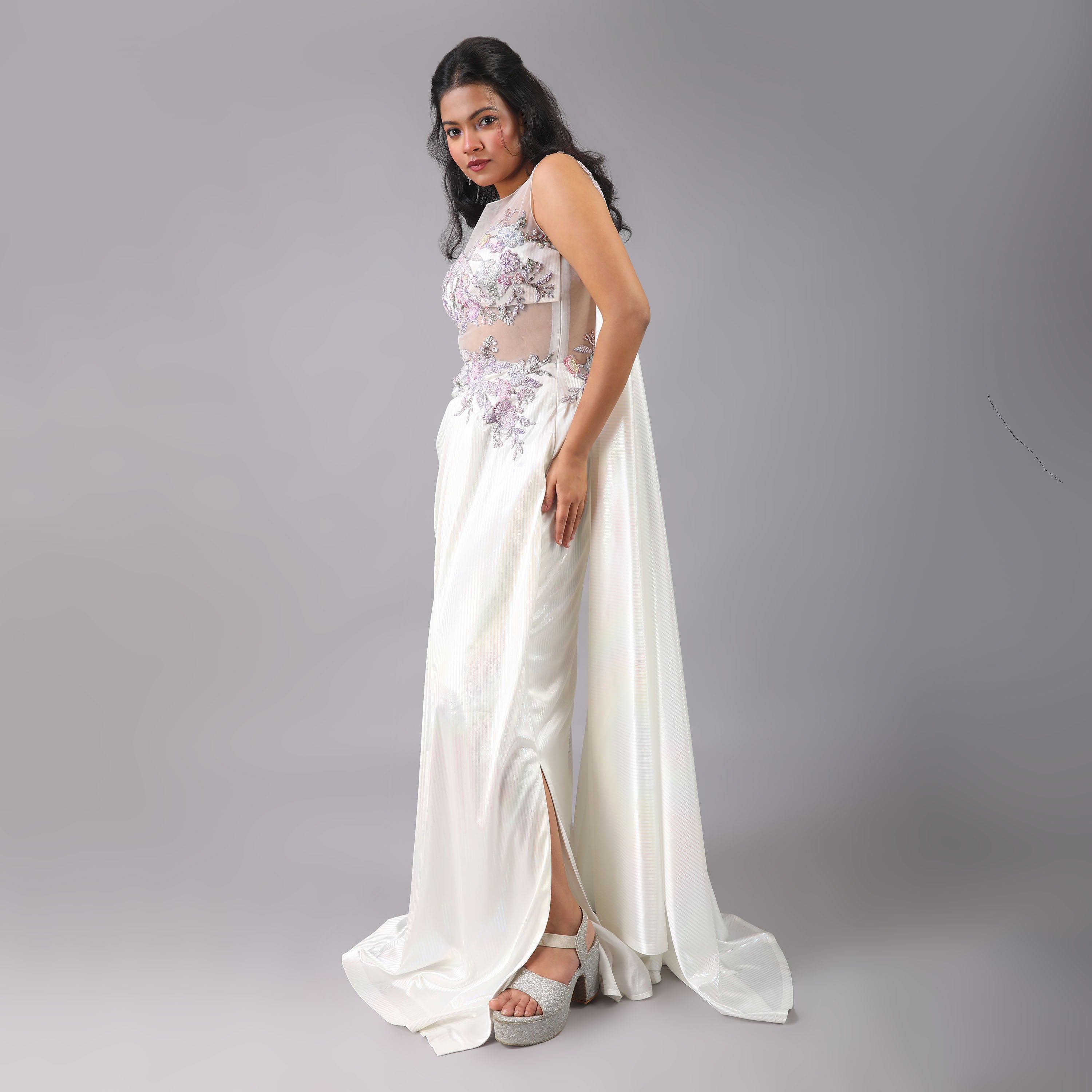 Stunning Holographic White multicolor pre-draped saree gown with floral embellishments on it. - qivii