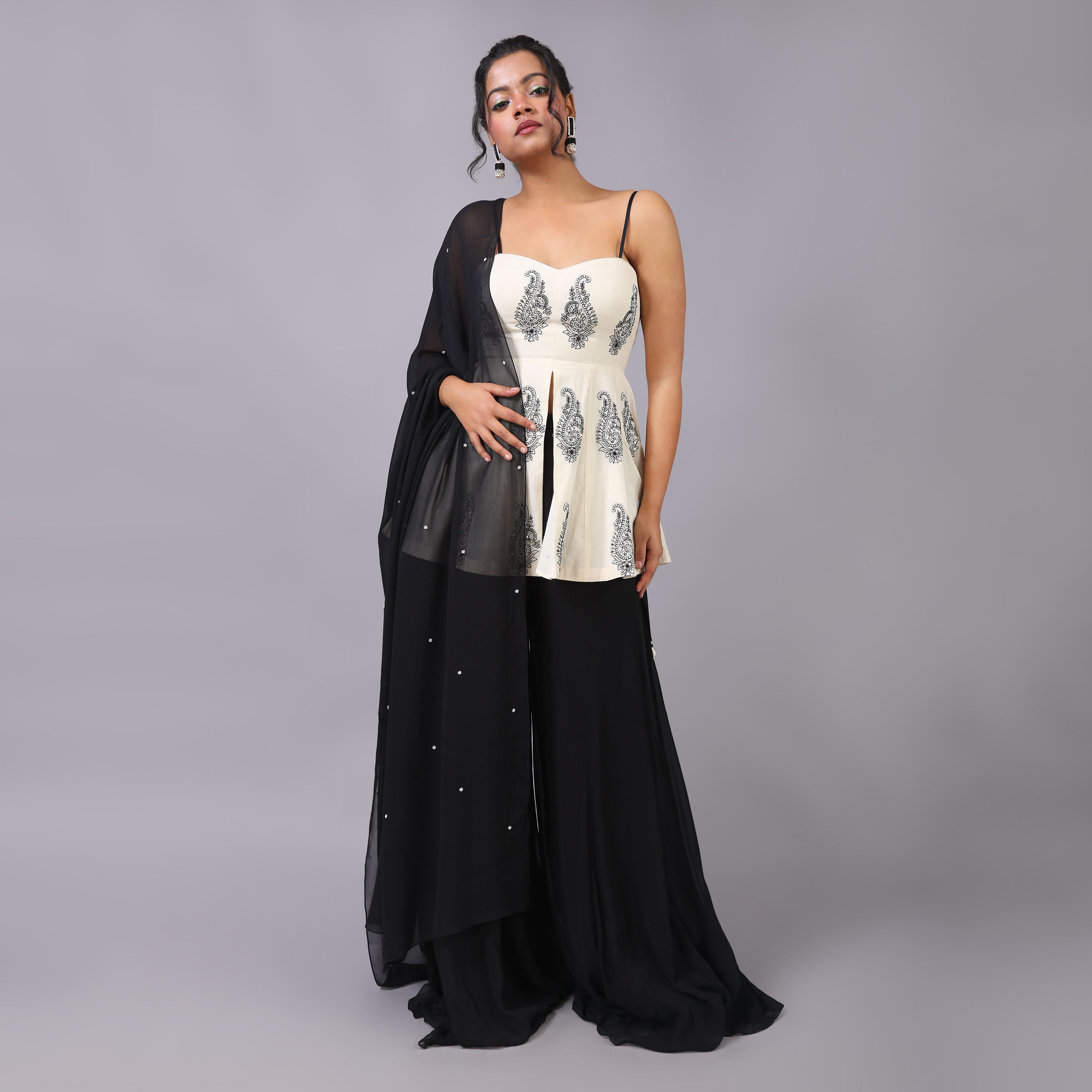 Elegant Ivory Peplum with black georget sharara and dupatta with hightlight of beads all over it. - qivii