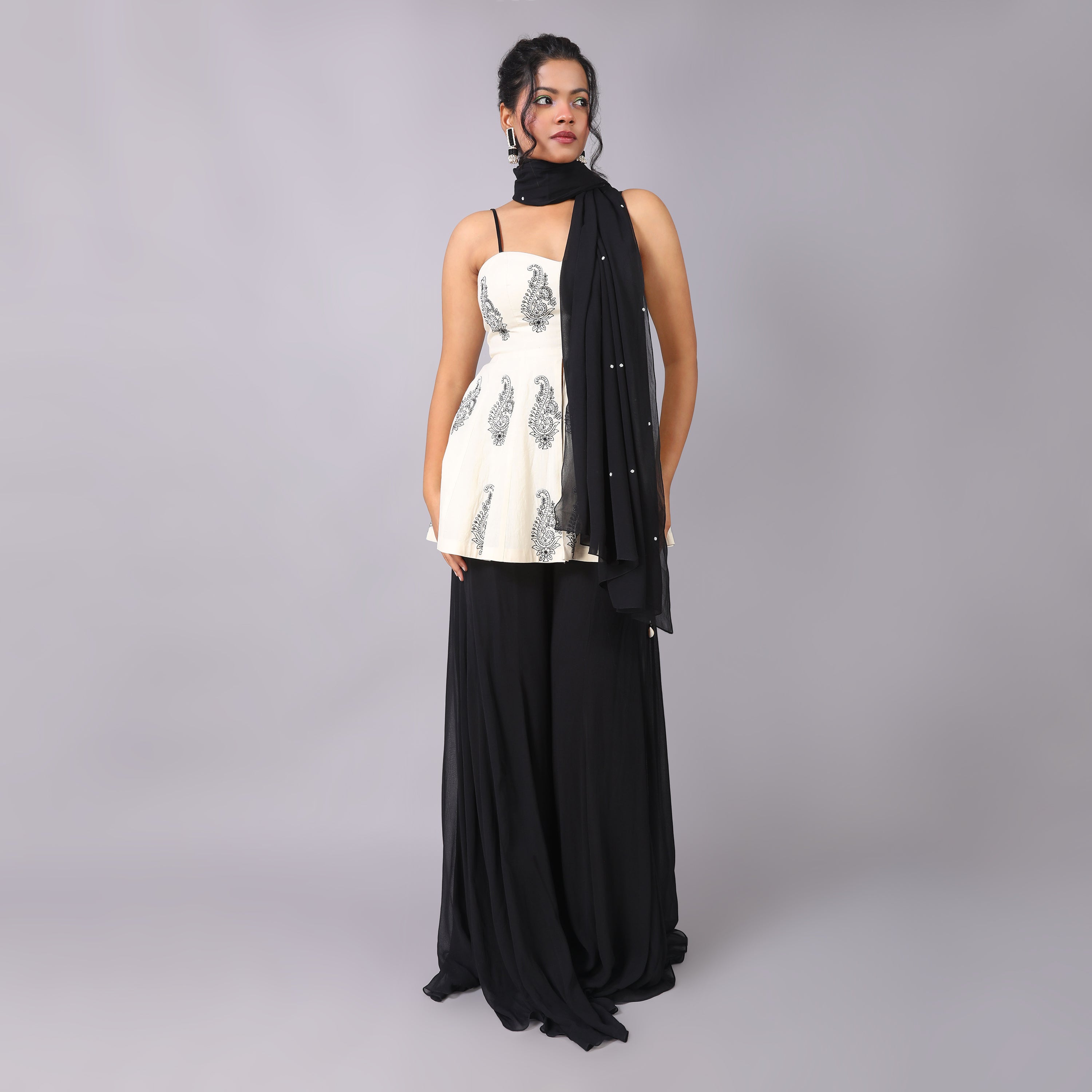 Elegant Ivory Peplum with black georget sharara and dupatta with hightlight of beads all over it. - qivii