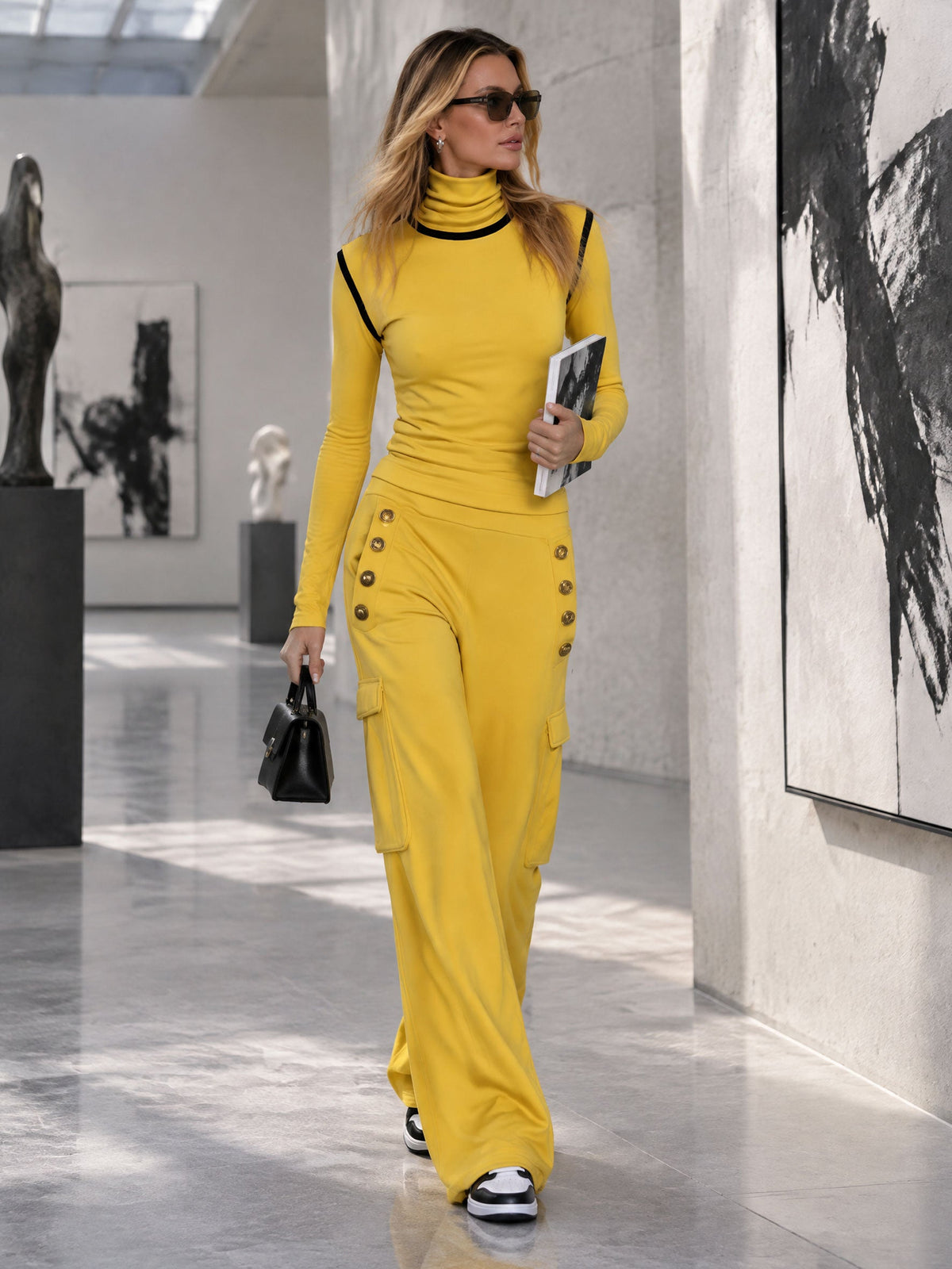 Women's yellow turtleneck long-sleeved top with black trim paired with black cargo pants, by Oyrosy Clothing, styled for casual wear.