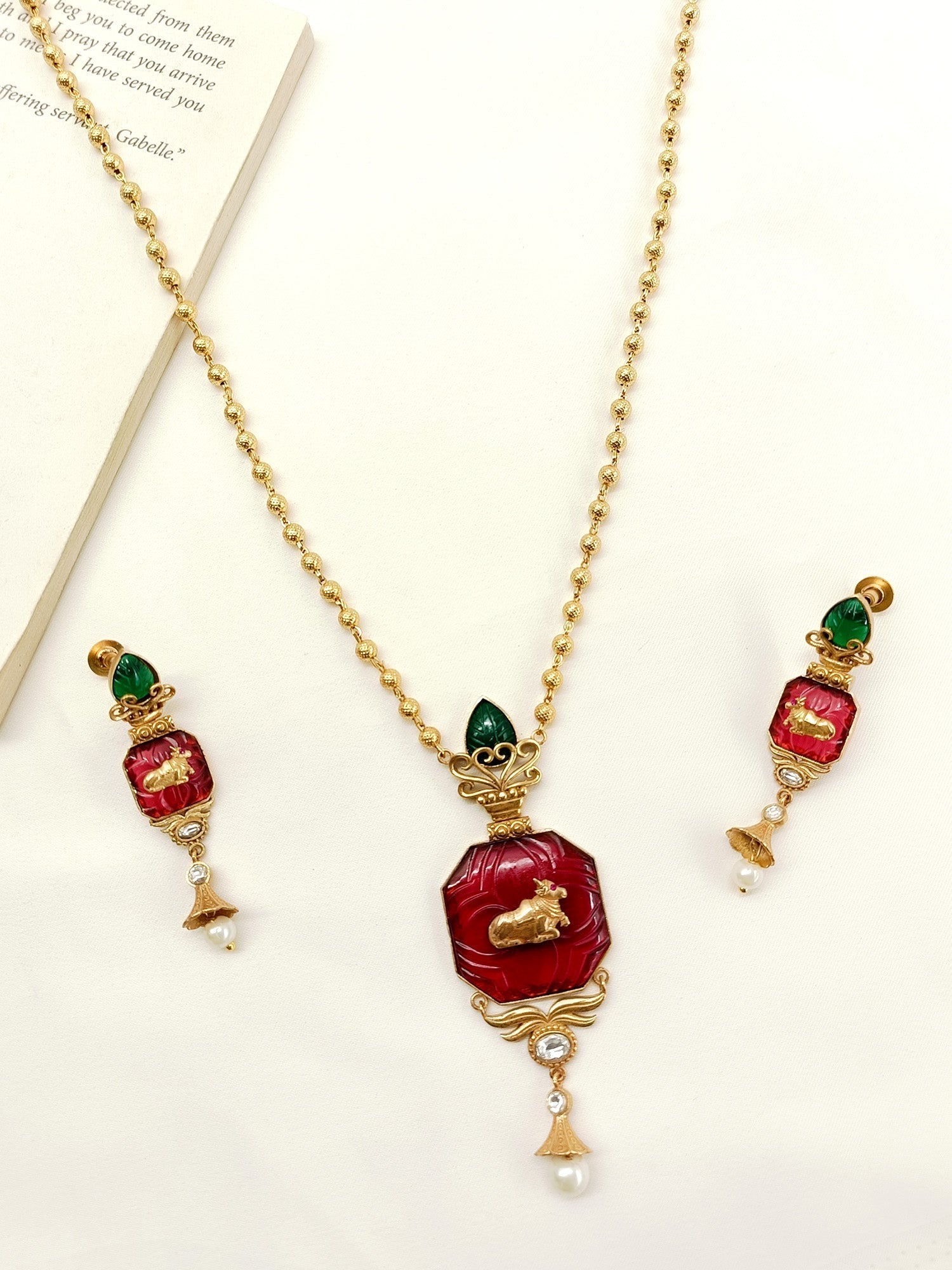 Gold plated brass metal pendant set with intricate cow motifs