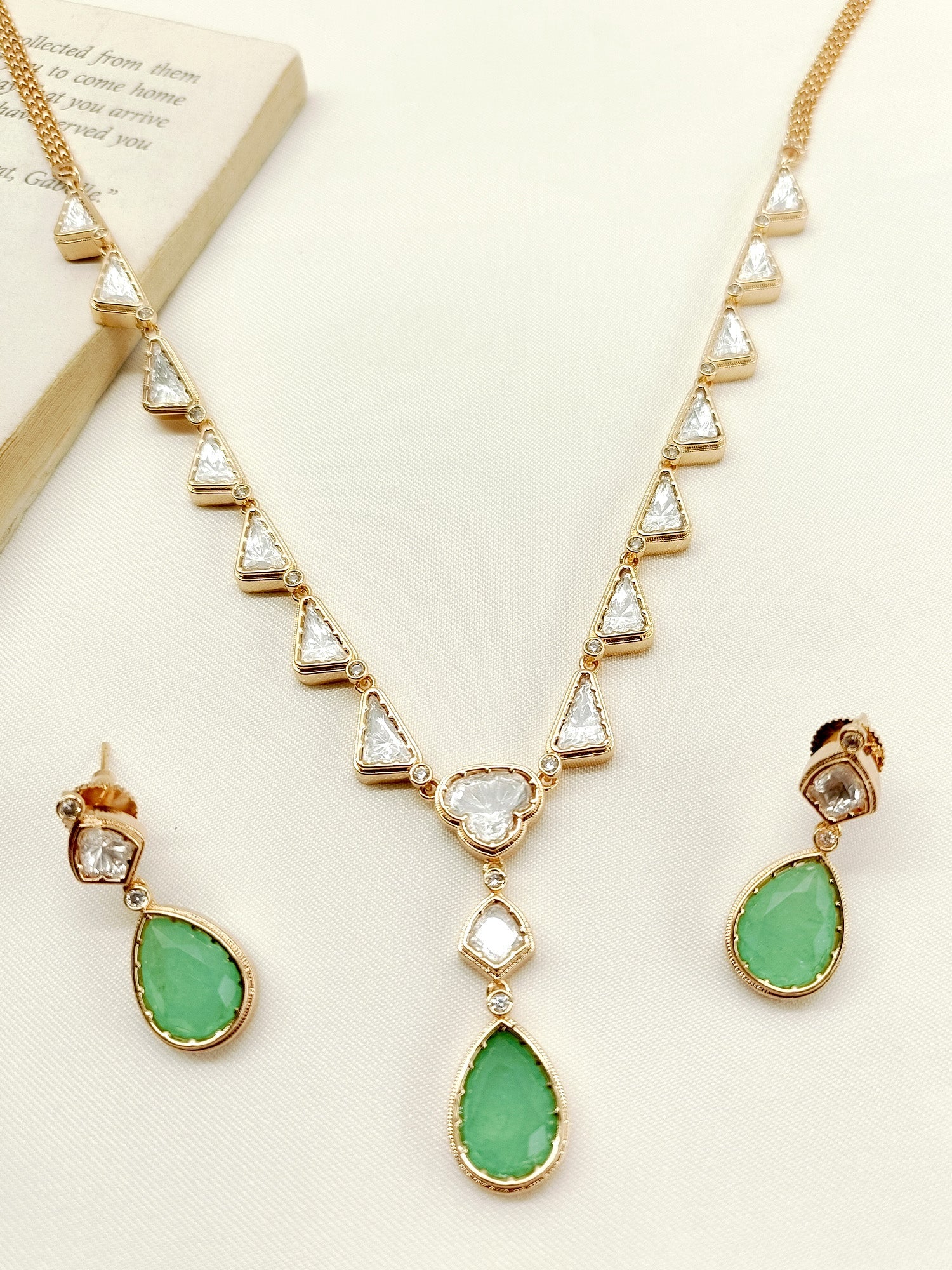 Gold plated brass metal Kundan necklace set in mint green with intricate details and sparkling Kundan for a timeless and elegant look