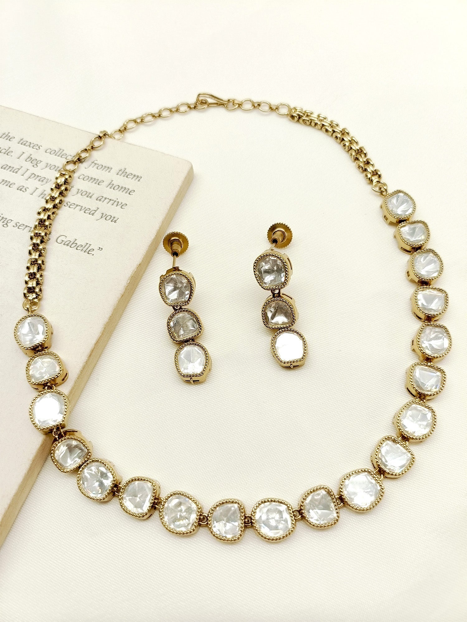 Close up of Elisha White Polki Necklace Set with antique gold plating and American diamond setting