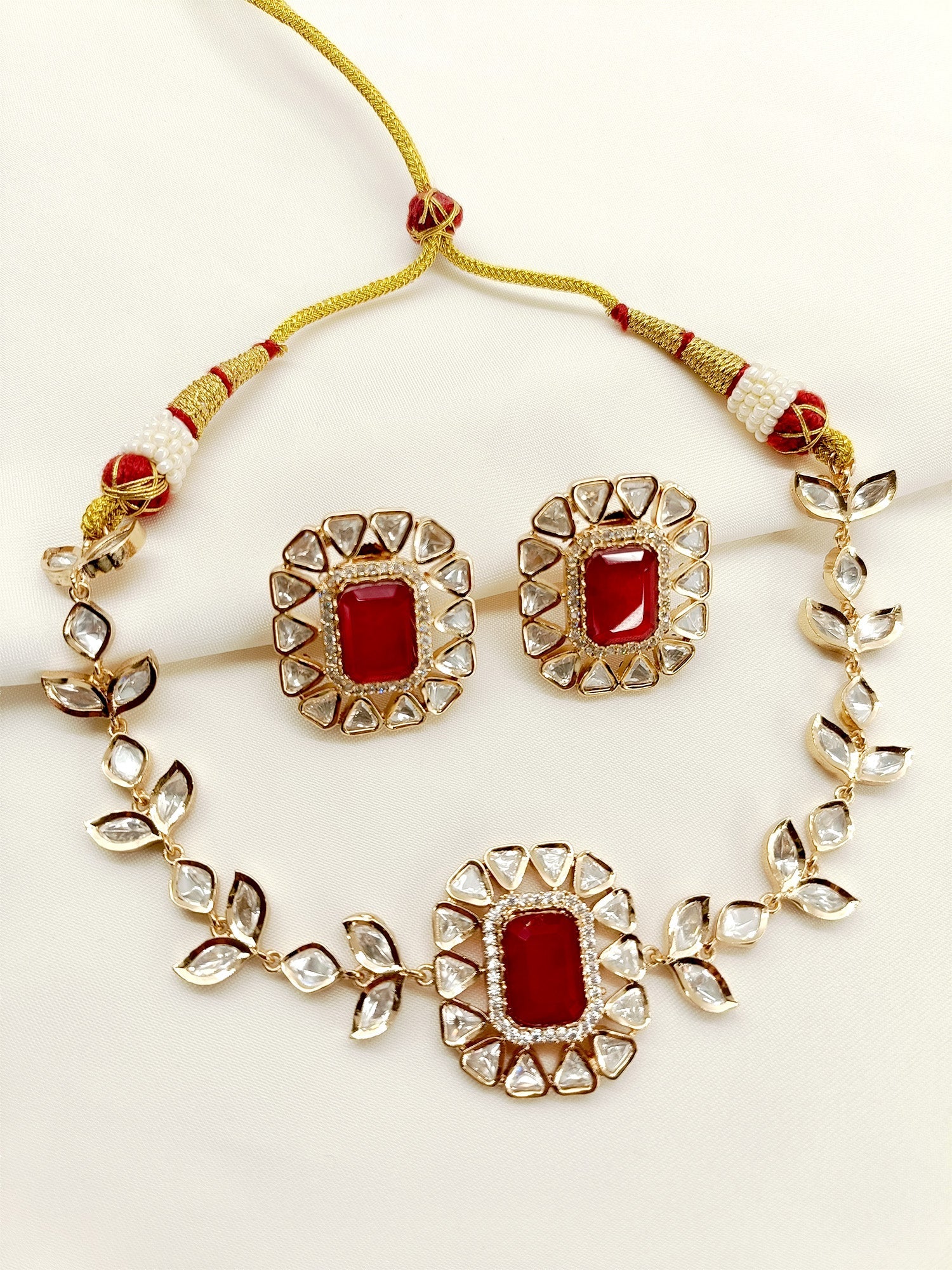 Stuti Ruby Kundan Choker Set, a beautiful blend of Kundan craftsmanship and gold plated brass metal, handcrafted to add elegance and sophistication to any occasion, perfect for lovers of Indian jewelry