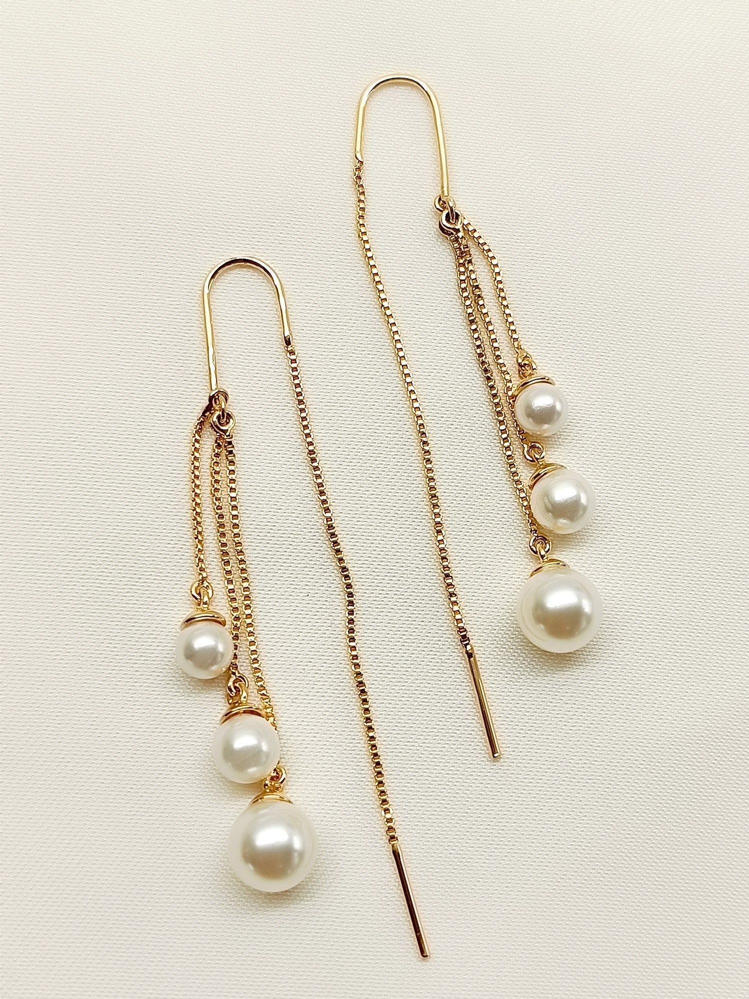Hanging gold plated brass Sui Dhaga pearl earrings with elegance