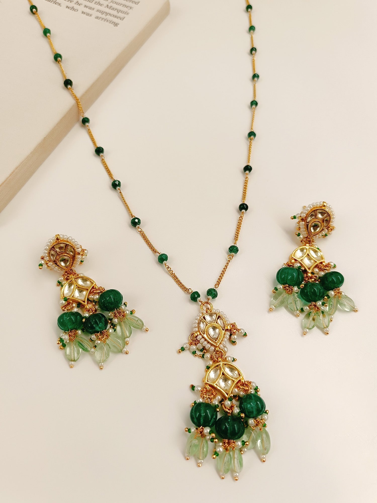 Gold plated brass metal pendant set adorned with green beads and pearl hanging