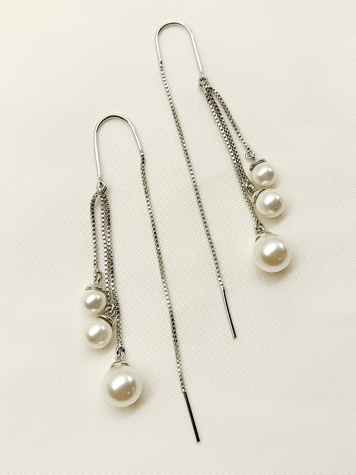 Rabhya White Sui Dhaga Pearl Earrings crafted from silver plated brass metal with stunning pearl, exuding elegance and sophistication, perfect for any occasion