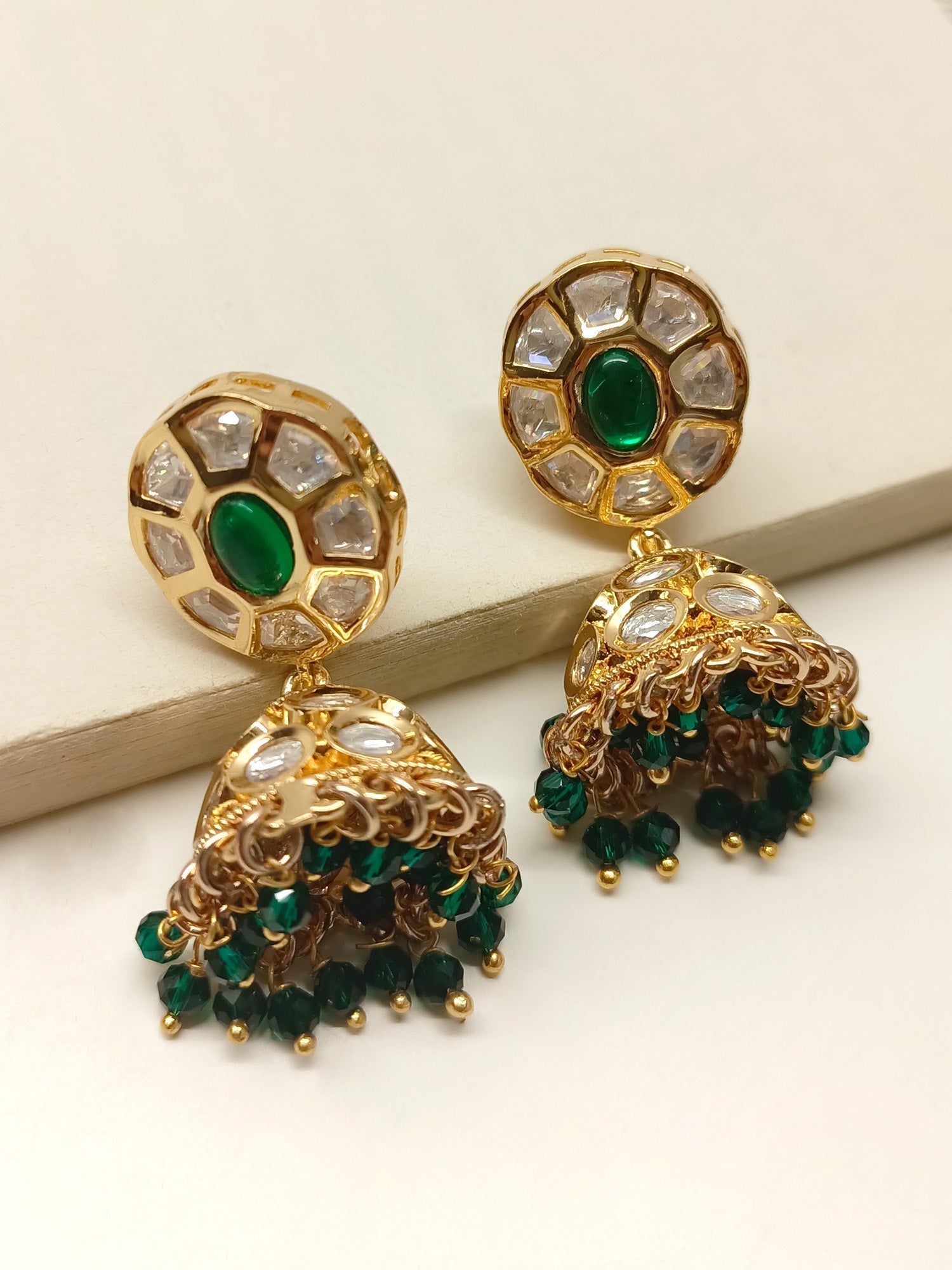 Kimora Green Kundan Jhumki crafted from gold plated brass with delicate green bead hanging, perfect traditional accessory