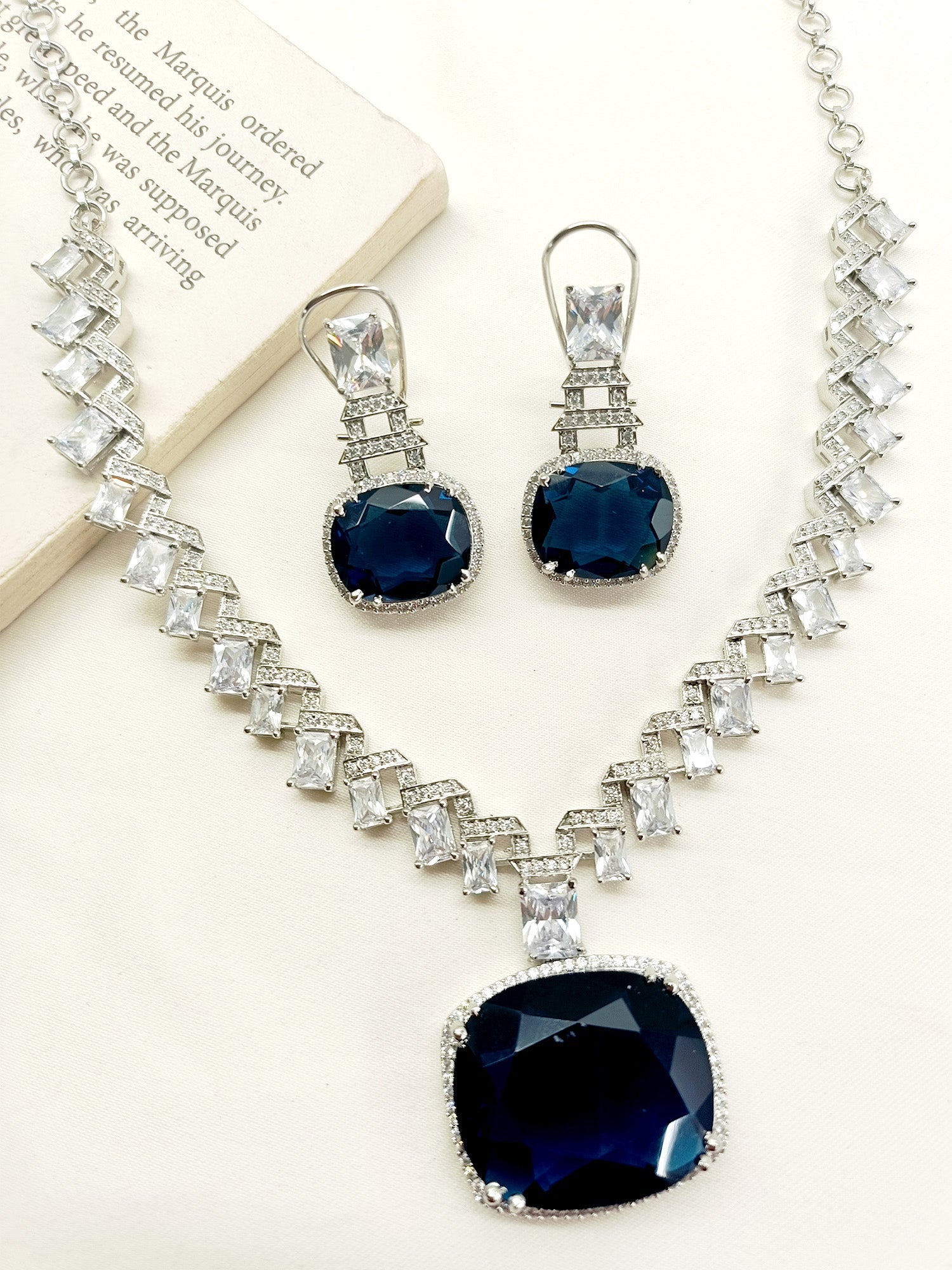 Kamia Navy Blue American Diamond Necklace Set featuring a Silver Plated Brass Metal Chain and Sparkling American Diamonds, perfect for adding glamour and sophistication to any outfit Durable and eye-catching