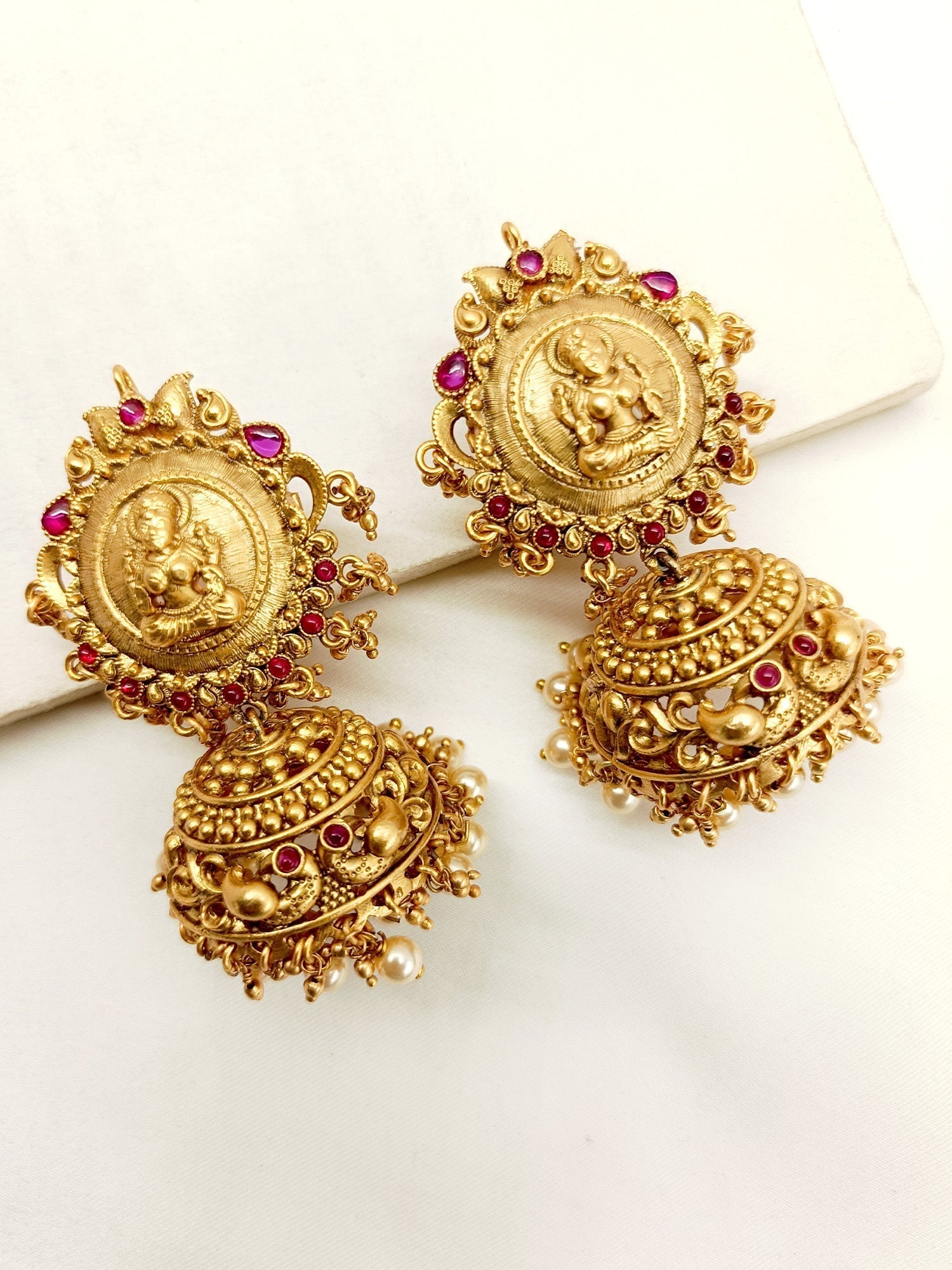 Gold-plated brass metal jhumki with intricate temple motifs for elegant look