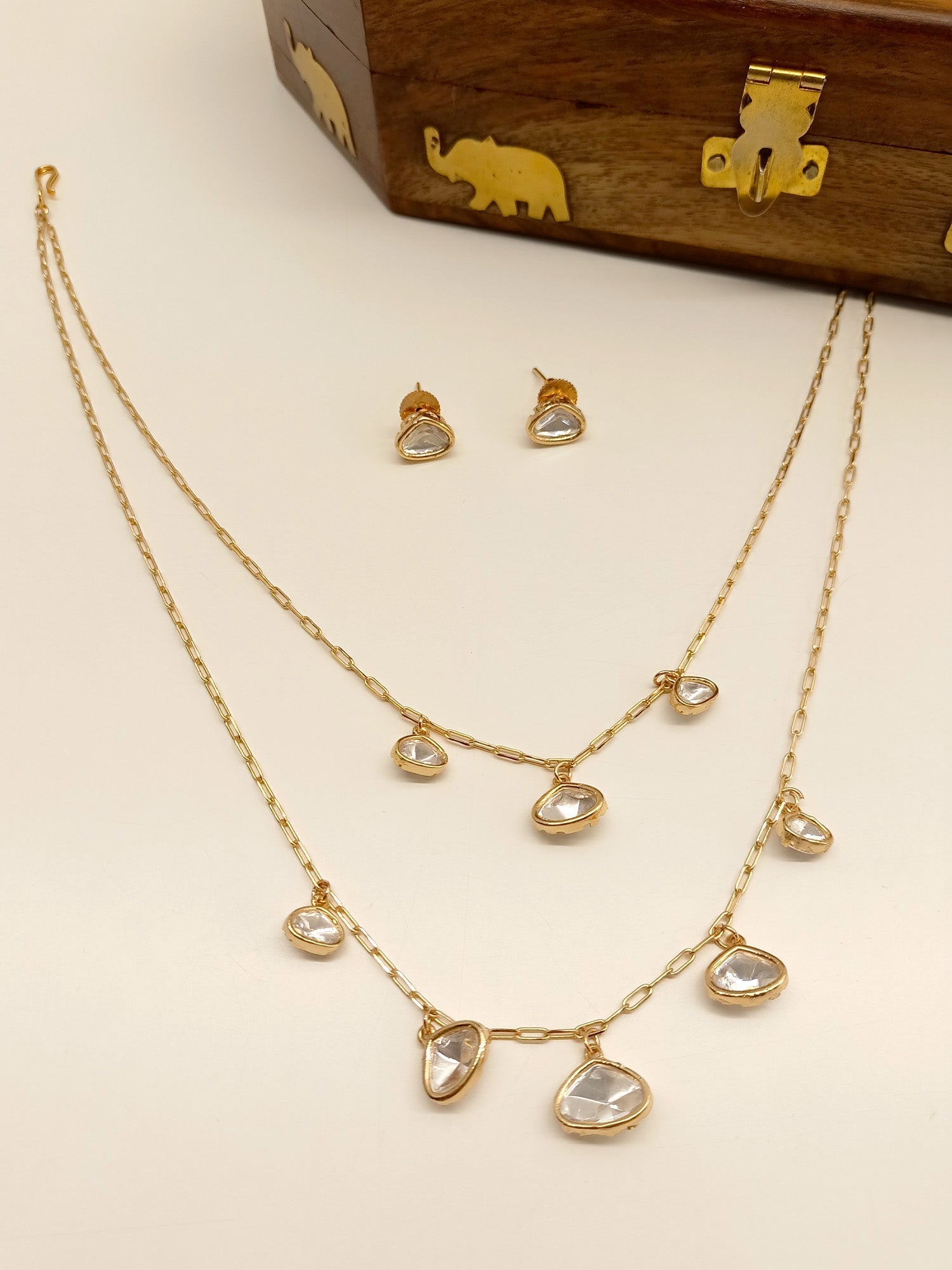 Gold-plated double layered Kundan pendant set with intricate detailing and stunning design