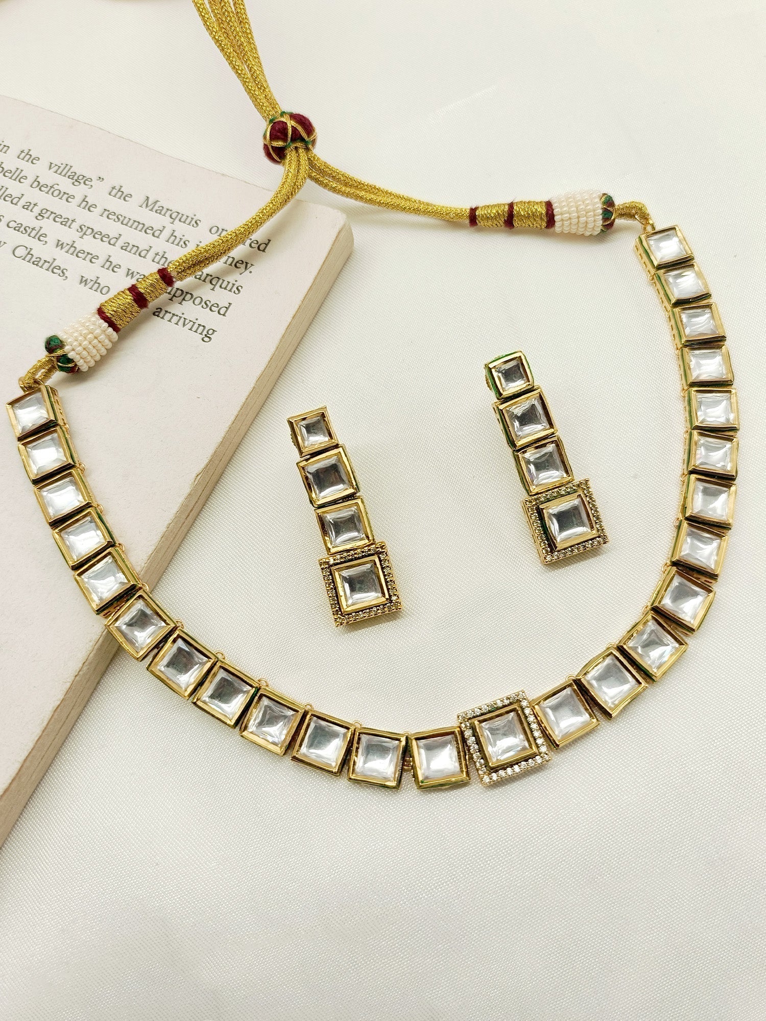 Close-up of a single-layered Gulabo White Kundan Necklace Set with gold plated brass metal and stunning array of Kundan stones