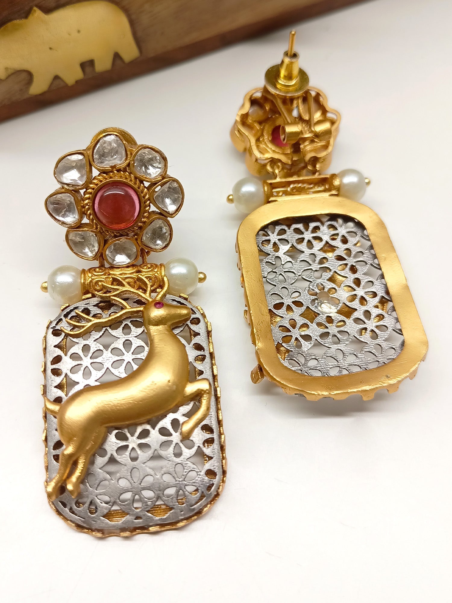 Intricate deer motifs with back-clip and pearl detailing