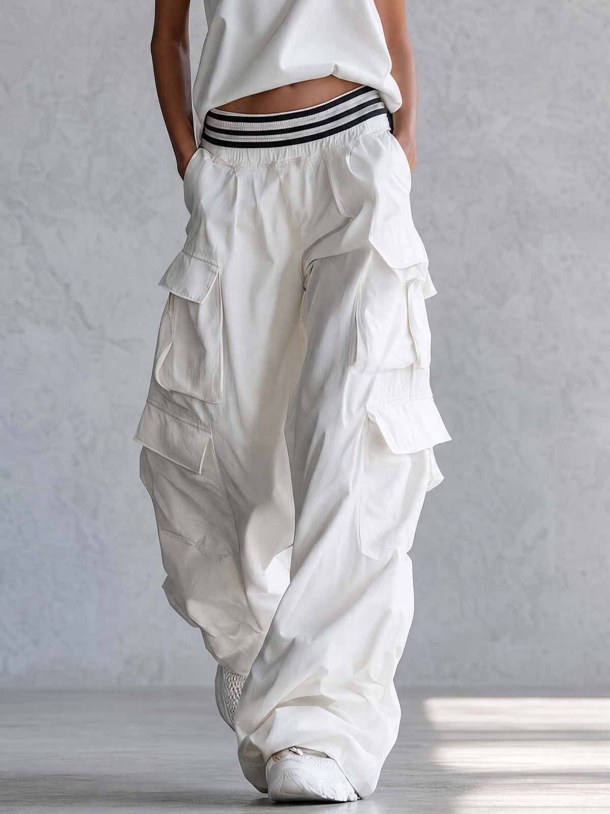 White cotton sleeveless athletic workwear top with mock neck and matching pants set from Oyrosy Clothing, perfect for active wear.