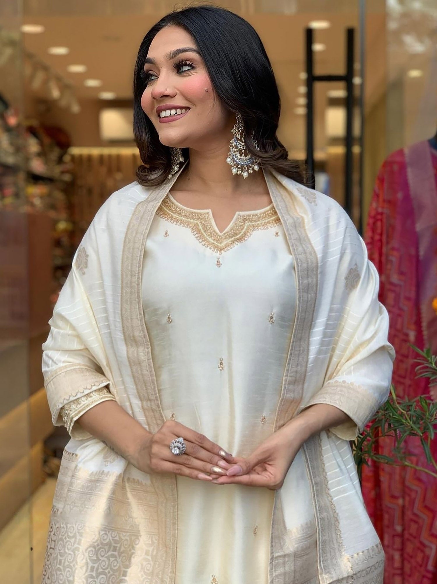 Off-white embroidered festival wear pant suit with intricate designs and patterns