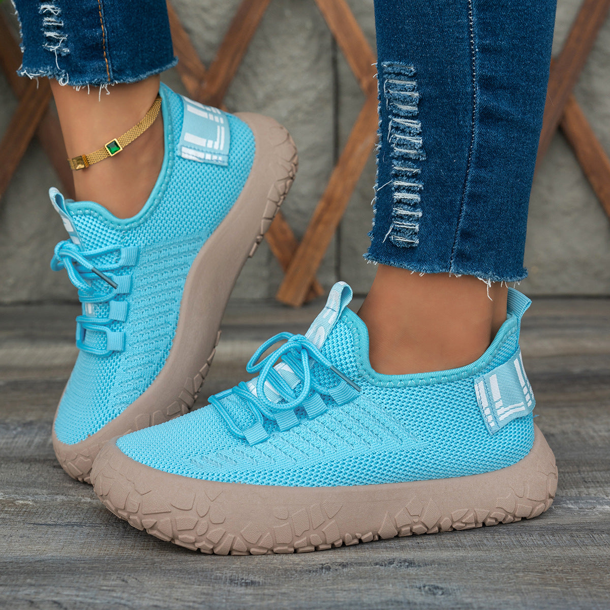 Blue women's Kestielle knit sneakers by Bootara with breathable slip-on design, laces, and chunky textured sole.