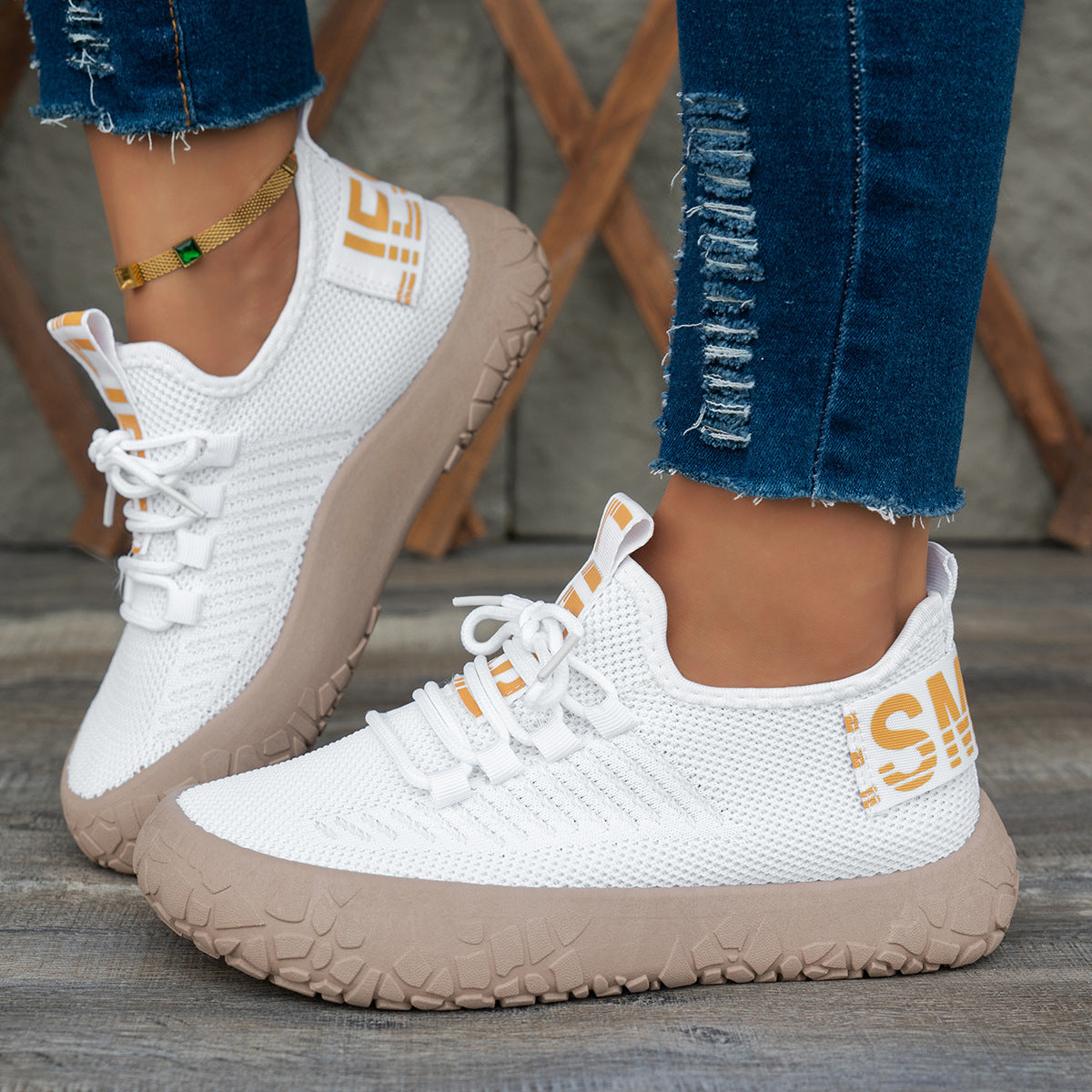 White women's Kestielle Knit Sneakers by Bootara with slip-on style, breathable fabric, laces, and chunky textured sole.