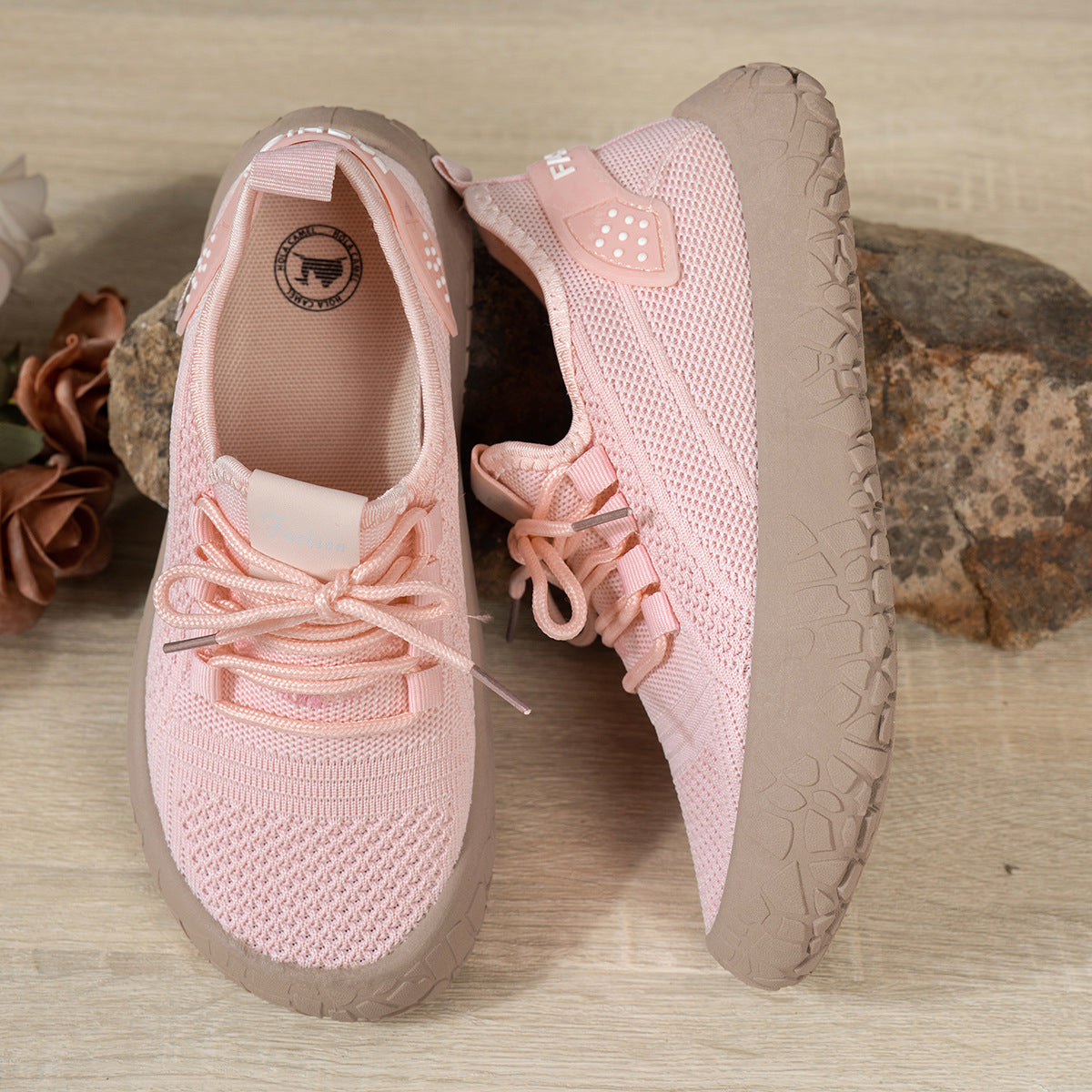 Women's pink Thessalie Knit Sneakers by Bootara with breathable fabric, slip-on design, laces, and textured chunky sole.