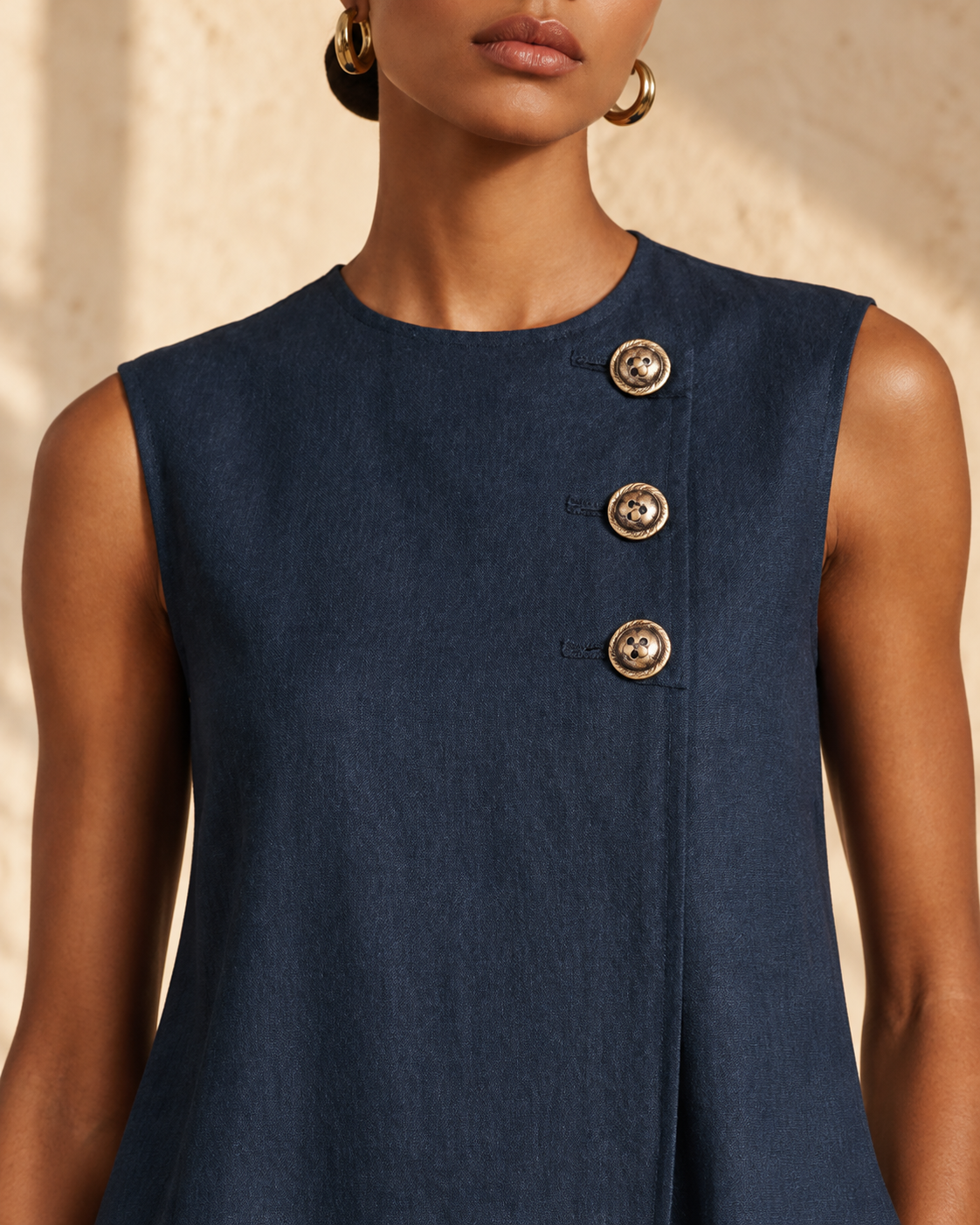 Women's navy blue linen mini dress by Modesees featuring round neck, asymmetric buttons, side pocket, sleeveless, minimalist commuter style
