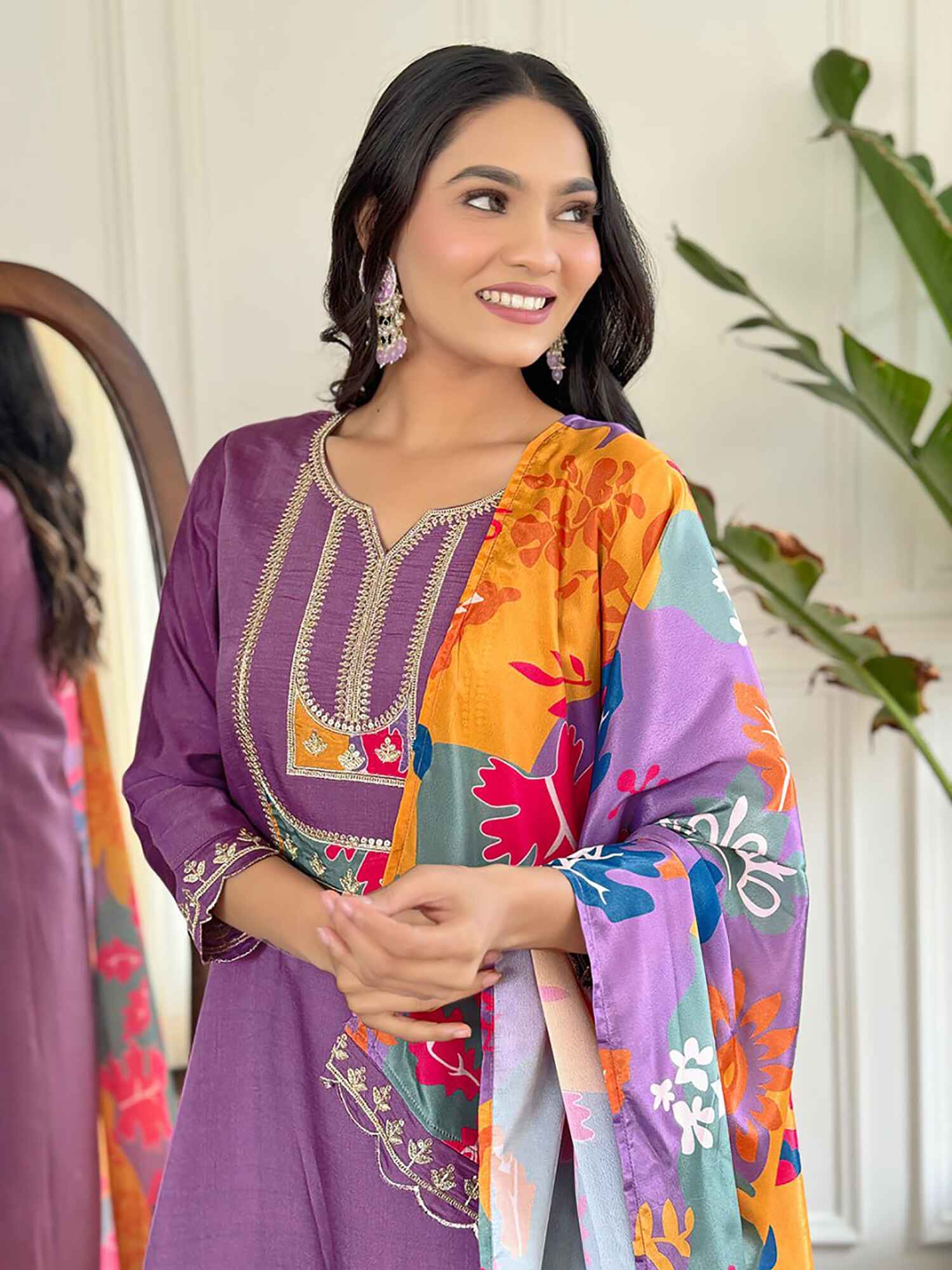 Close-up of intricate thread embroidery and delicate sequin detailing on purple suit