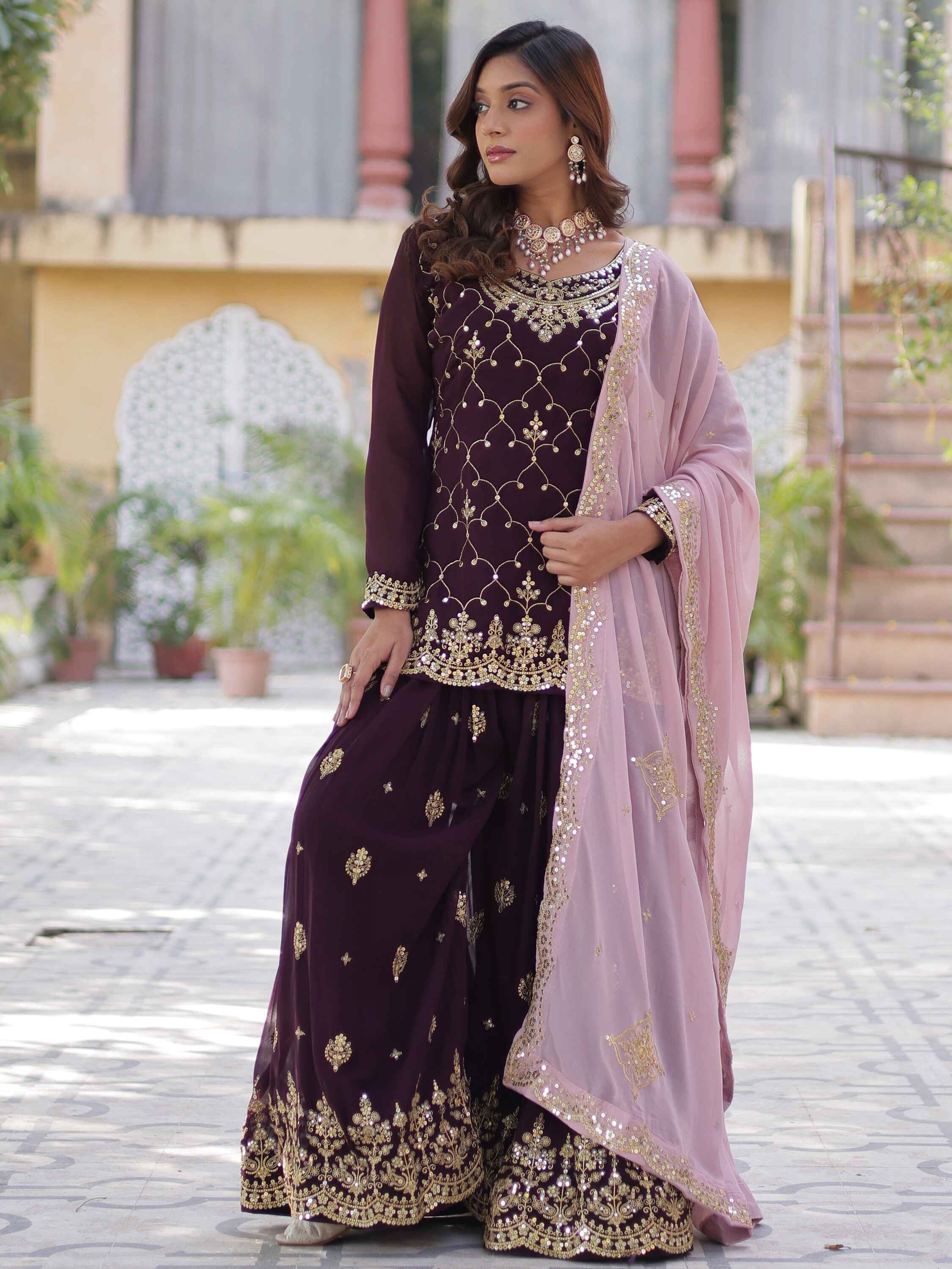 Luxurious wine-colored sharara suit with intricate sequins embroidery and stylish pan-shaped neck