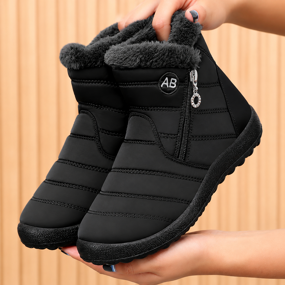 Women's Bootara Norwyn snow boots in black, water-resistant fleece-lined high-top style with side zipper.