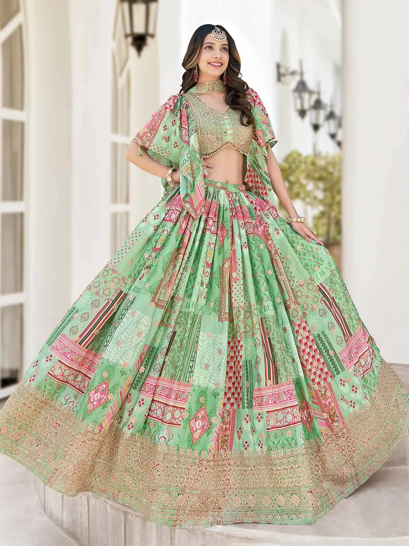 Woman wearing green floral lehenga choli with gold embroidery and dupatta, posing outdoors