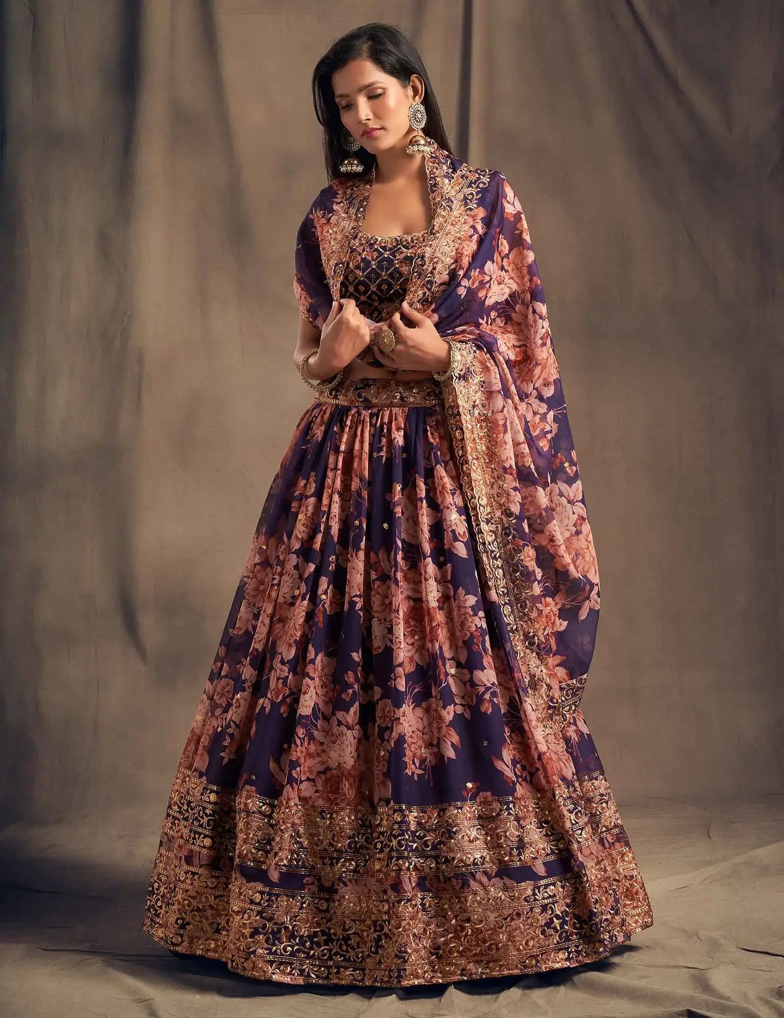 Woman in navy blue floral embroidered lehenga with dupatta, traditional ethnic attire