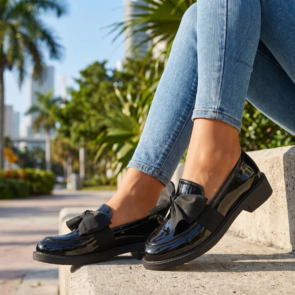 Black women's Lawrence Bow Loafers by Hudson Ridge, stylish slip-on footwear with a decorative bow detail.