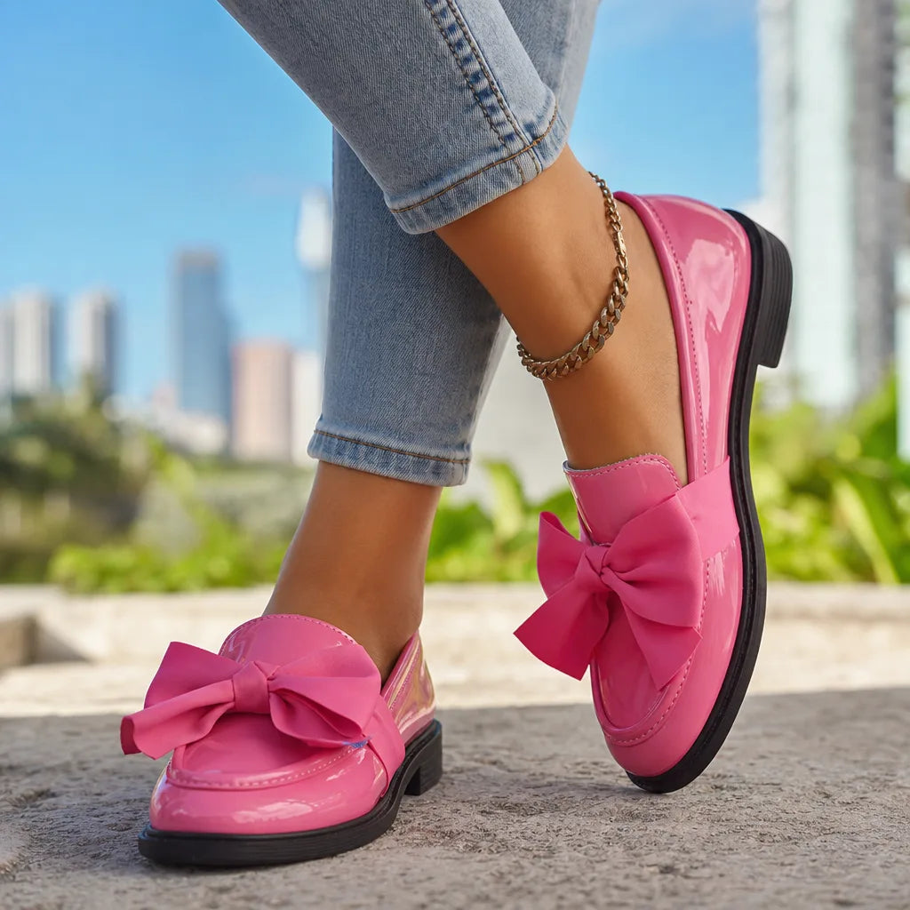 Pink women's bow loafers by Hudson Ridge, styled with a sleek design perfect for casual or dressy occasions.