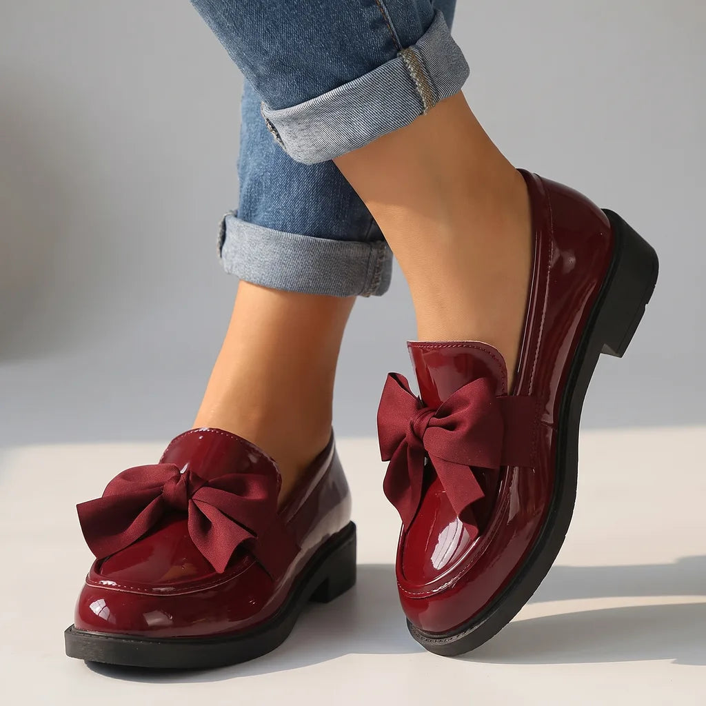 Red women's bow loafers by Hudson Ridge, stylish slip-on footwear with a decorative bow detail for women.