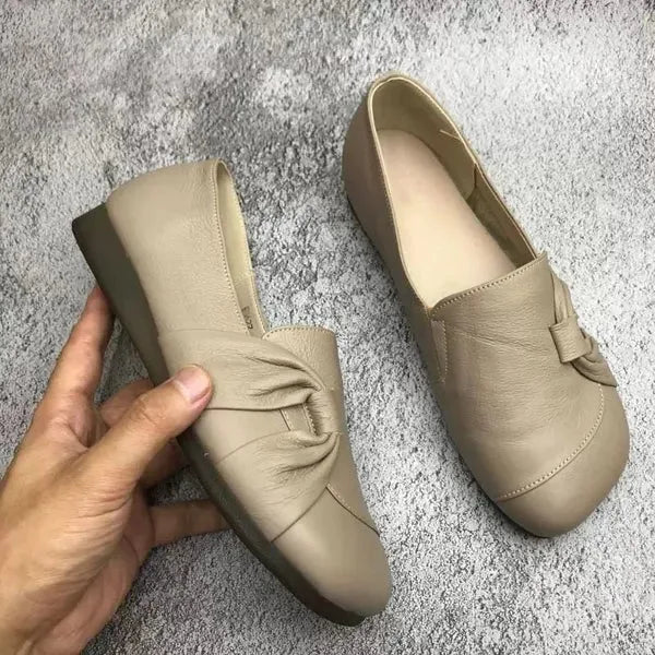 Beige women's orthopedic wedge flats by Hudson Ridge, featuring comfortable slip-on design with supportive soles and stylish appearance.