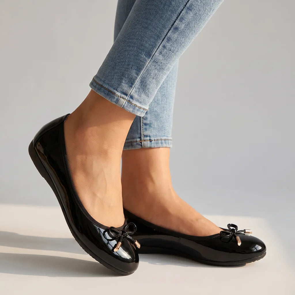 Black Wolfe women's ballet flats by Qivii featuring a sleek, slip-on design with a rounded toe and soft interior for comfortable wear.