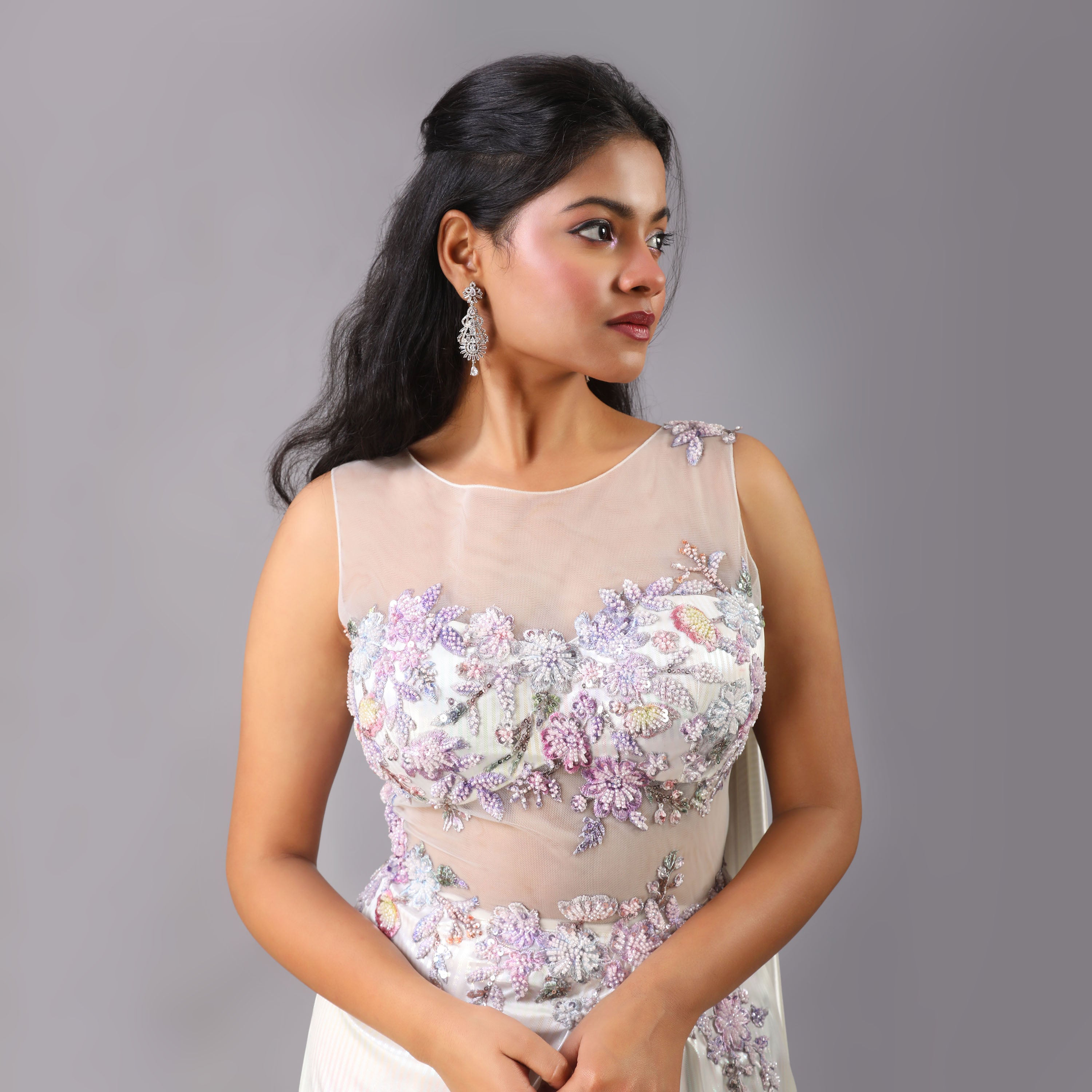 Stunning Holographic White multicolor pre-draped saree gown with floral embellishments on it. - qivii
