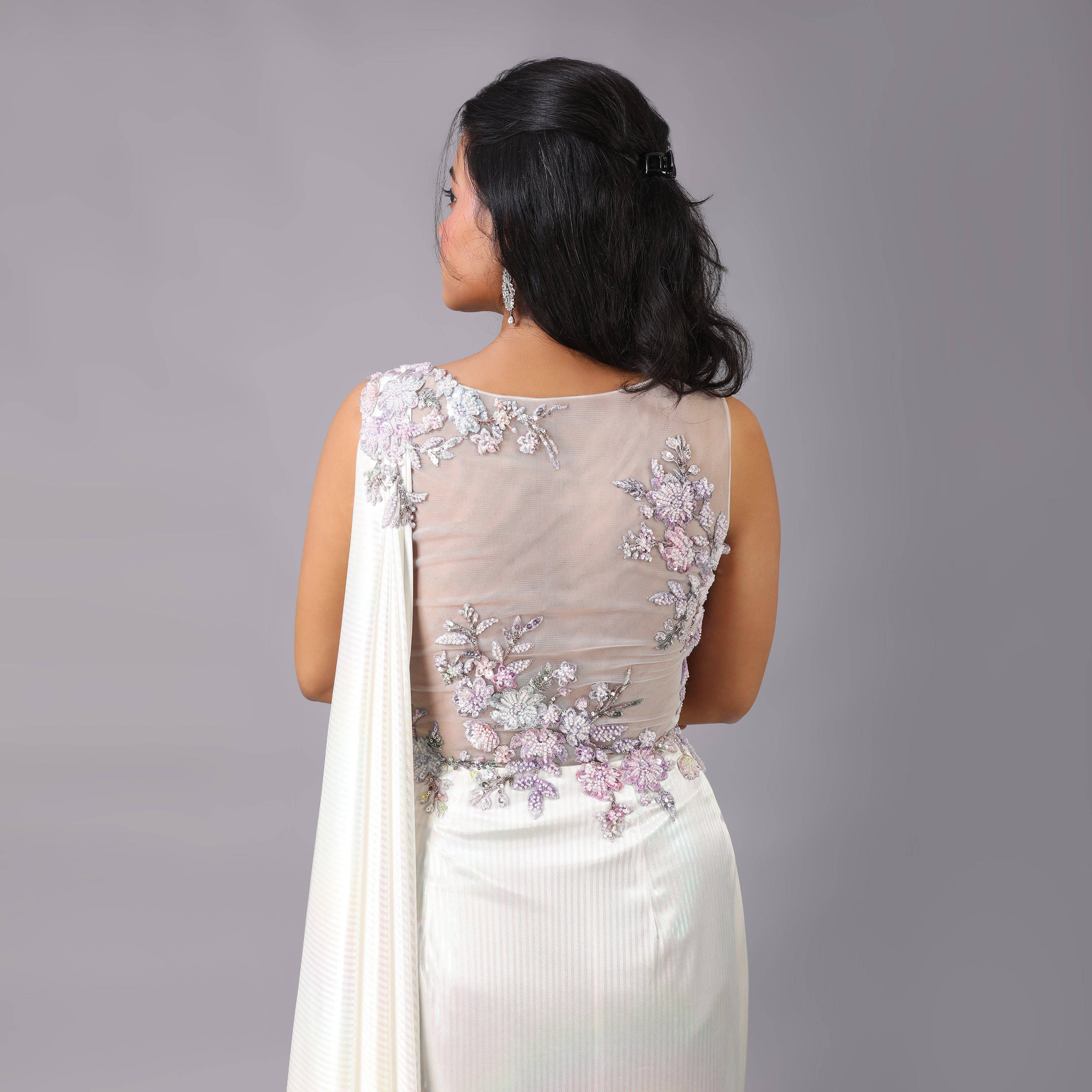 Stunning Holographic White multicolor pre-draped saree gown with floral embellishments on it. - qivii