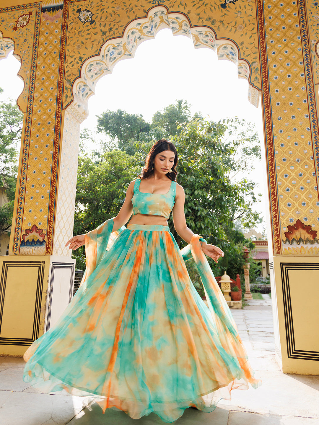 Nectarine Green Orange Chiffon Lehenga Set by Ragavi, a beautiful traditional Indian outfit with intricate embroidery and a flowing chiffon skirt