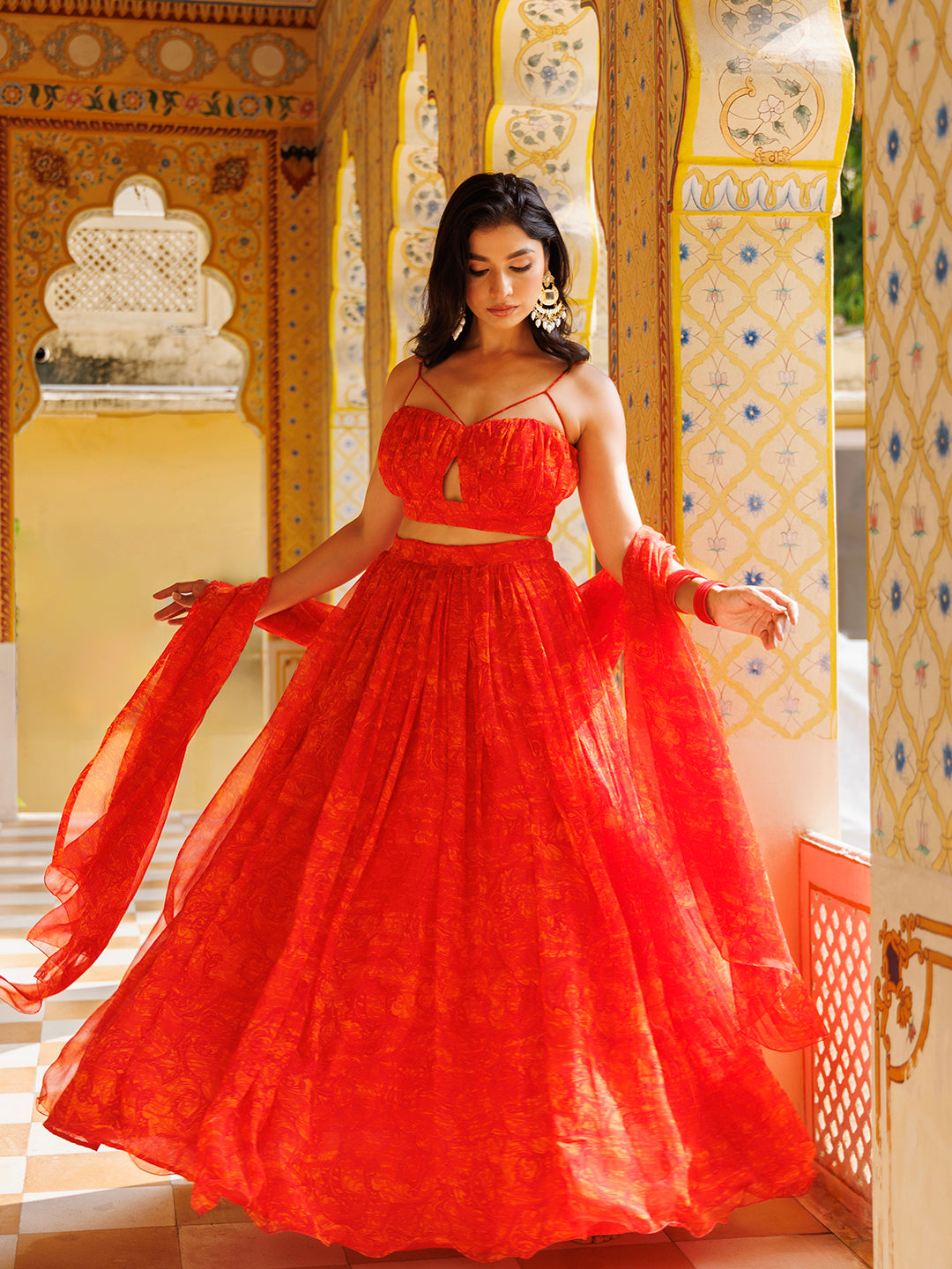 Beautiful Ragavi Orange Floral Chiffon Lehenga Set with gold detailing and stunning floral print