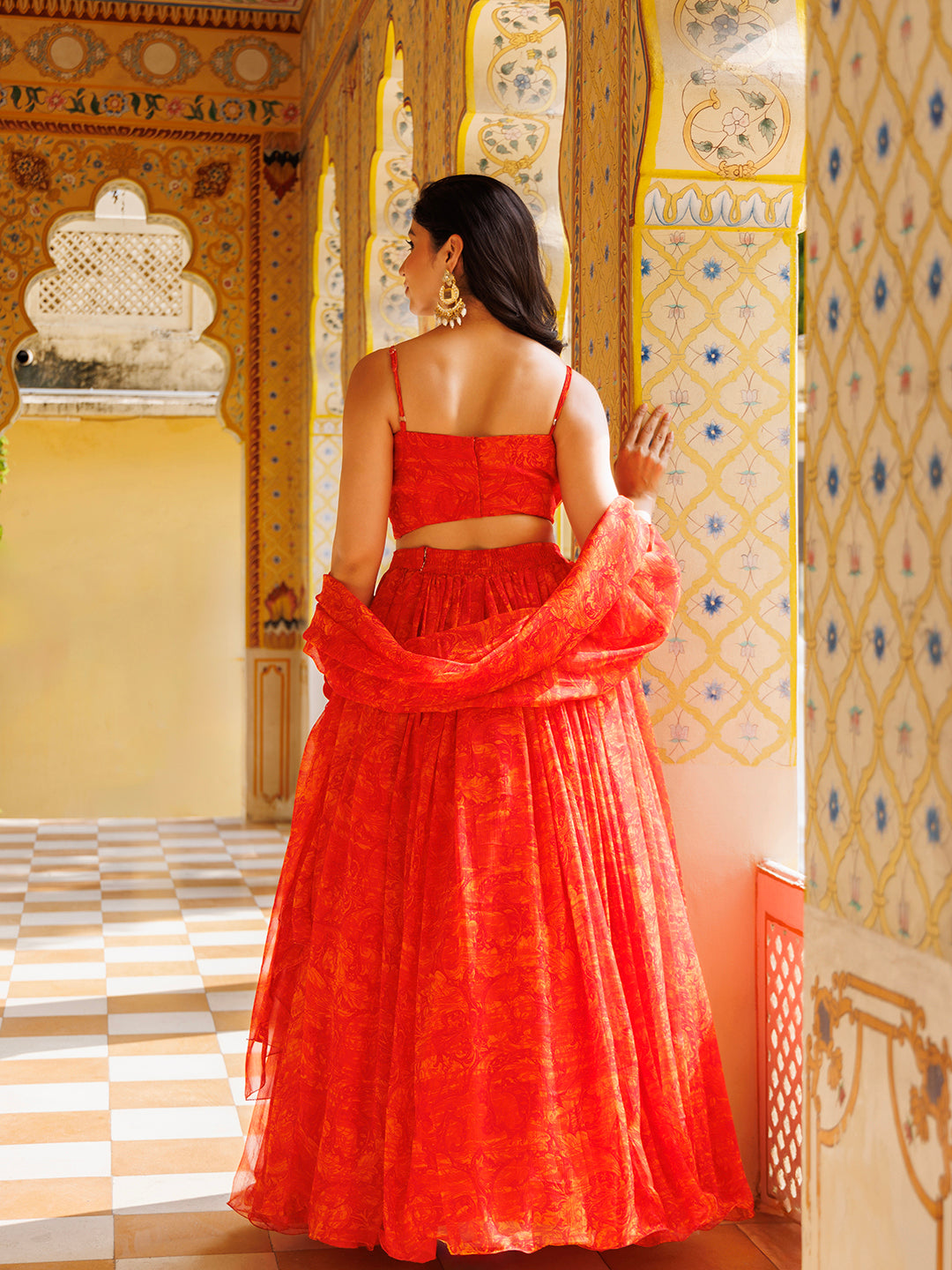 Elegant Ragavi Orange Floral Chiffon Lehenga Set with vibrant orange color and intricate floral patterns