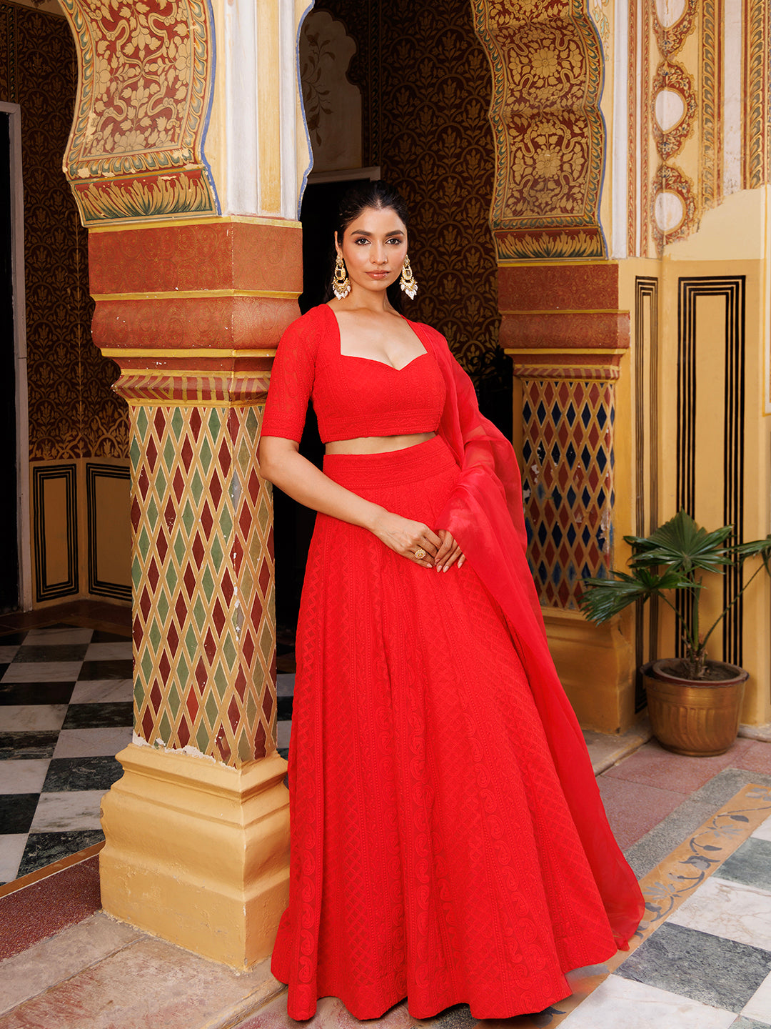 Stunning fire red lehenga set featuring traditional chikankari work