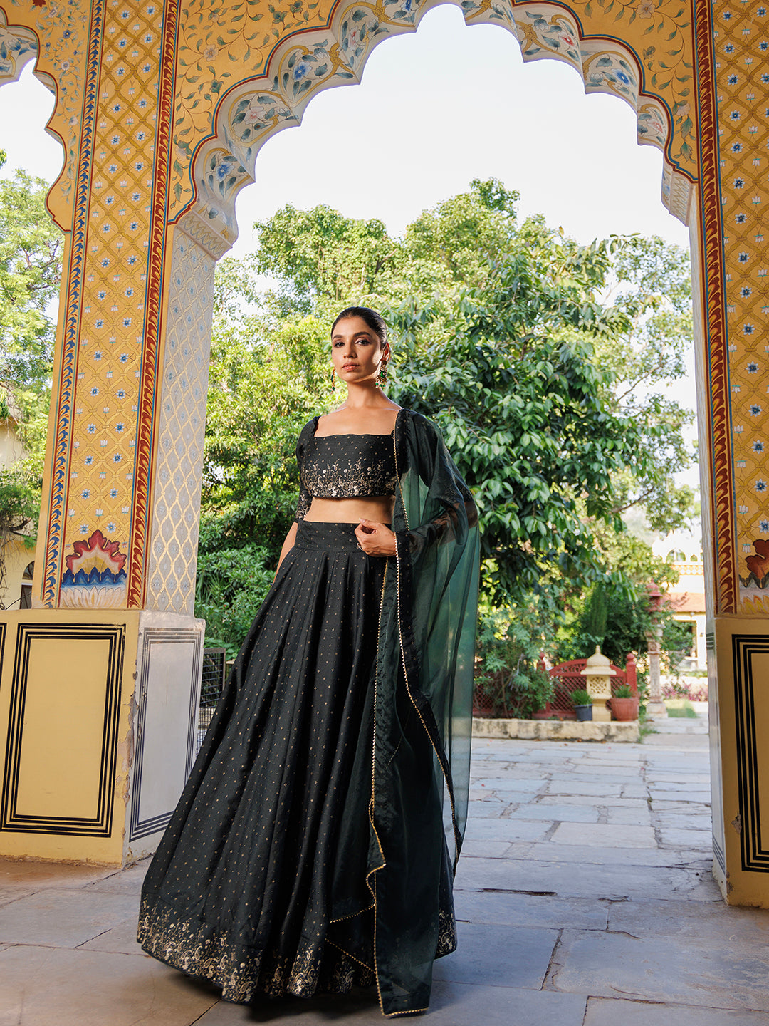  Elegant Colonial Green Gold Foil Printed Silk Lehenga Set by Ragavi displayed on a mannequin