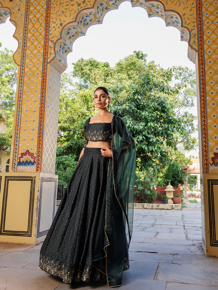  Elegant Colonial Green Gold Foil Printed Silk Lehenga Set by Ragavi displayed on a mannequin