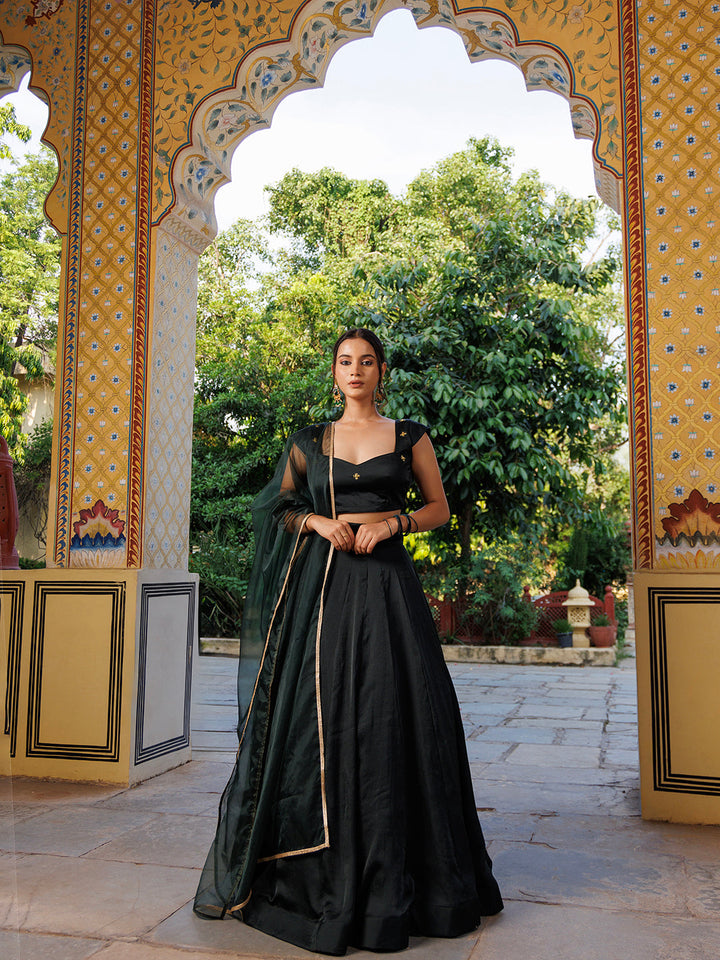 Close-up of Green Bay Embroidered Silk Lehenga Set skirt in emerald green with intricate gold embroidery and floral motifs