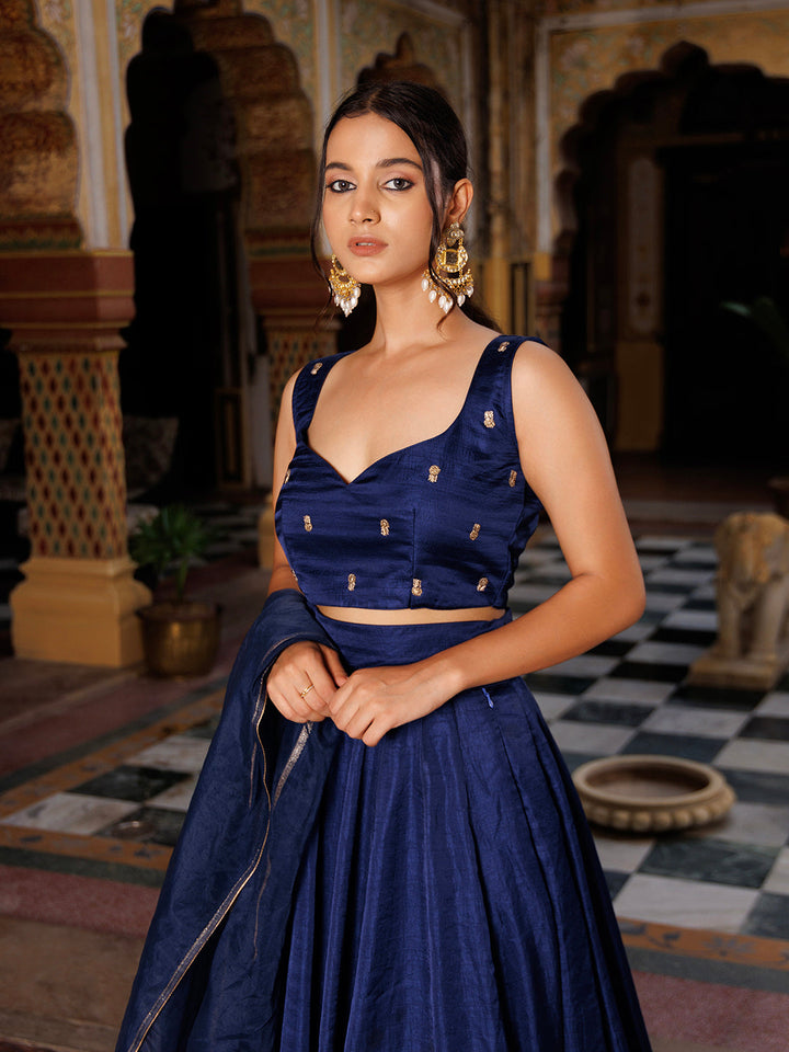 A group of friends admiring the Deja Vu Blue Embroidered Silk Lehenga Set - By Ragavi at a special event