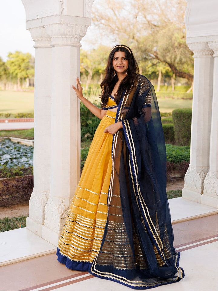 Sunset Gold Yellow and Navy Blue Lehenga Set BY RAGAVI