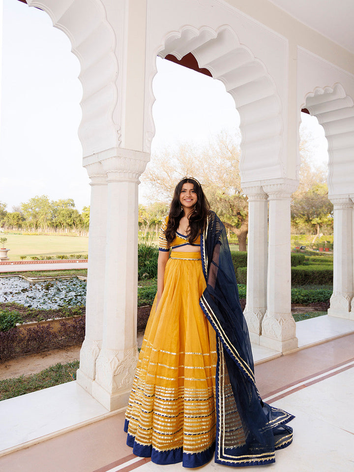 Sunset Gold Yellow and Navy Blue Lehenga Set BY RAGAVI