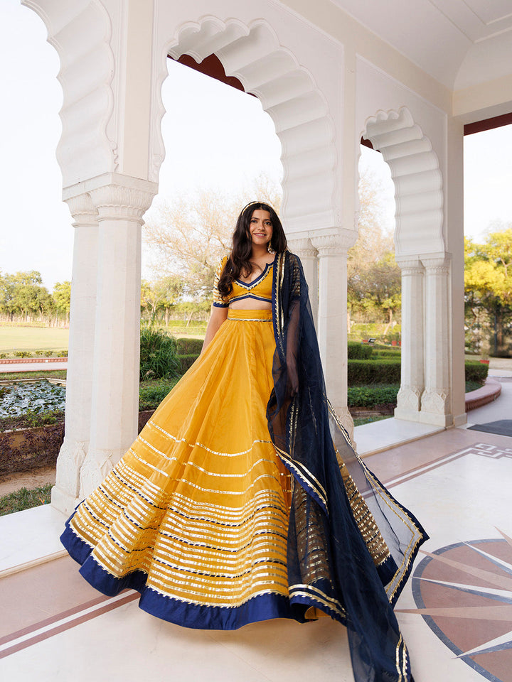 Sunset Gold Yellow and Navy Blue Lehenga Set BY RAGAVI