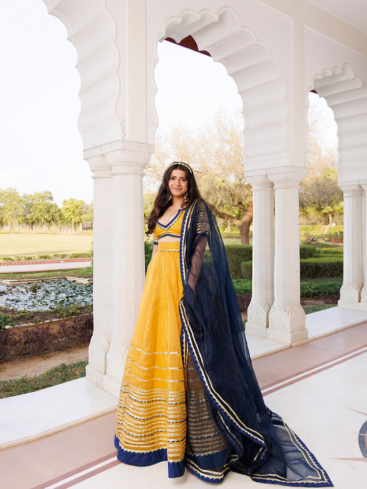 Sunset Gold Yellow and Navy Blue Lehenga Set BY RAGAVI