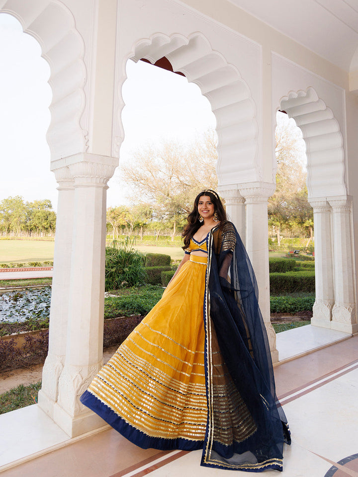 Sunset Gold Yellow and Navy Blue Lehenga Set BY RAGAVI