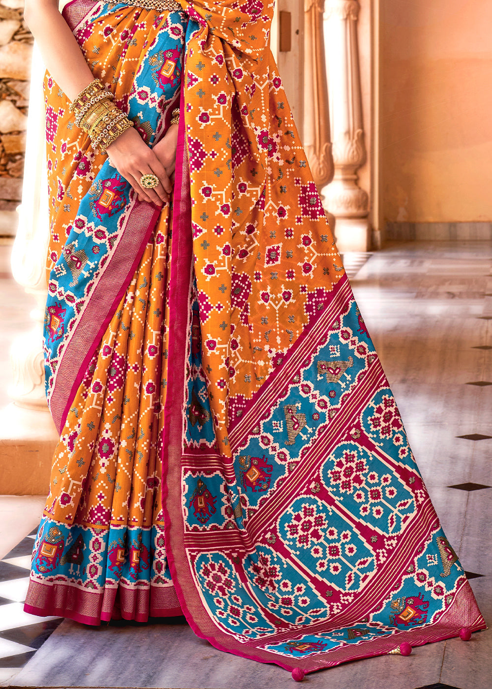 Elegant Patola Silk Saree in Atomic Orange with Gold Border and Floral Print